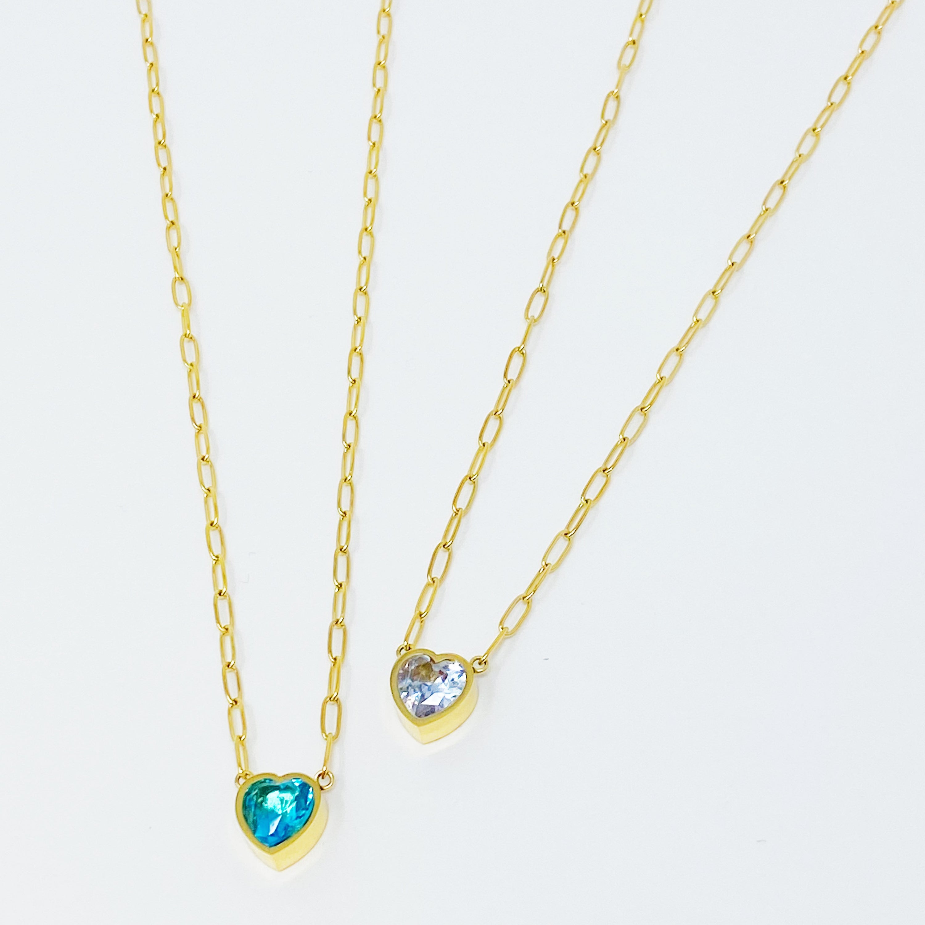 Chained To My Heart Necklace featuring a sparkly heart pendant and trendy link chain, showcasing its reversible design.