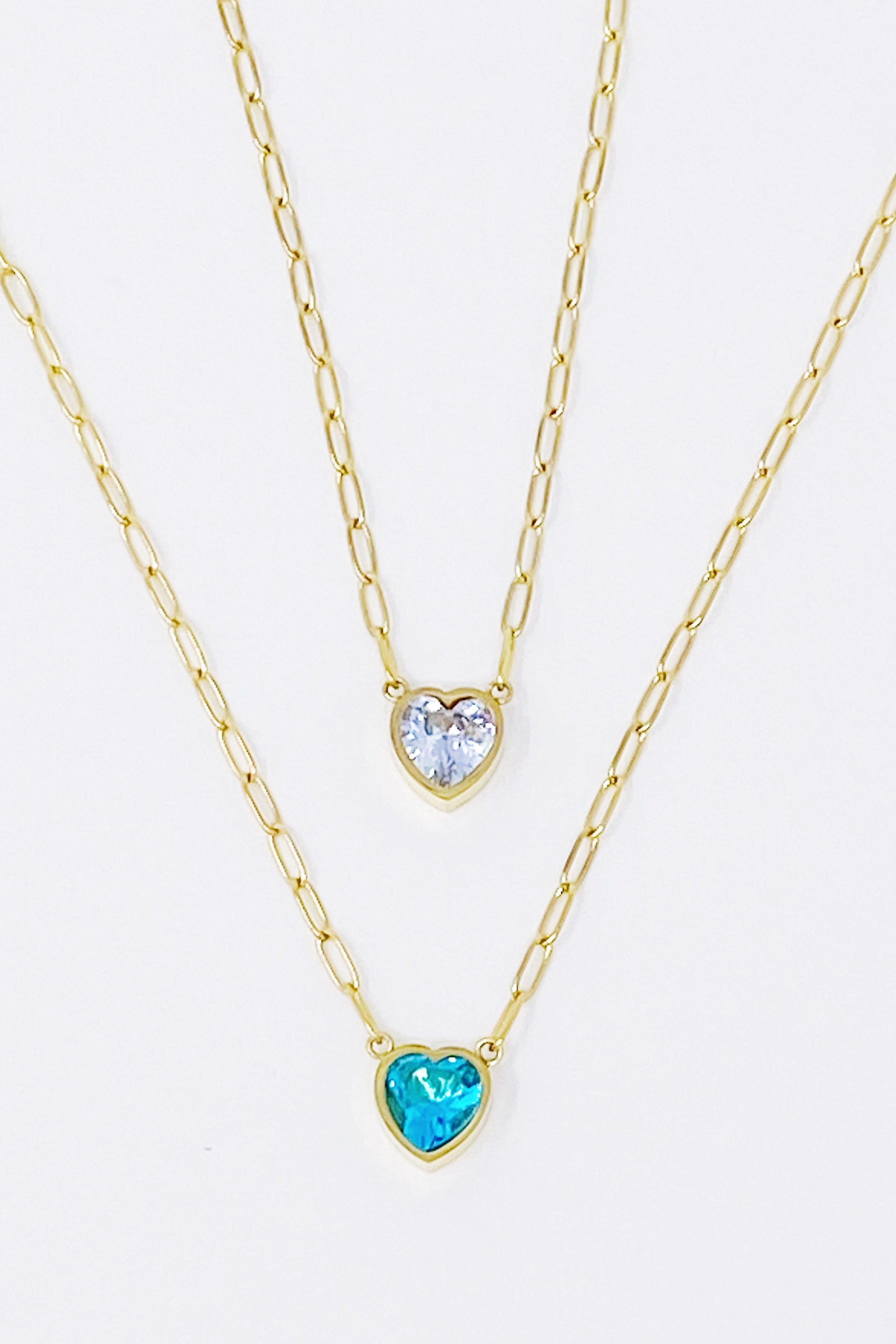 Chained To My Heart Necklace featuring a sparkly heart pendant and trendy link chain, showcasing its reversible design.