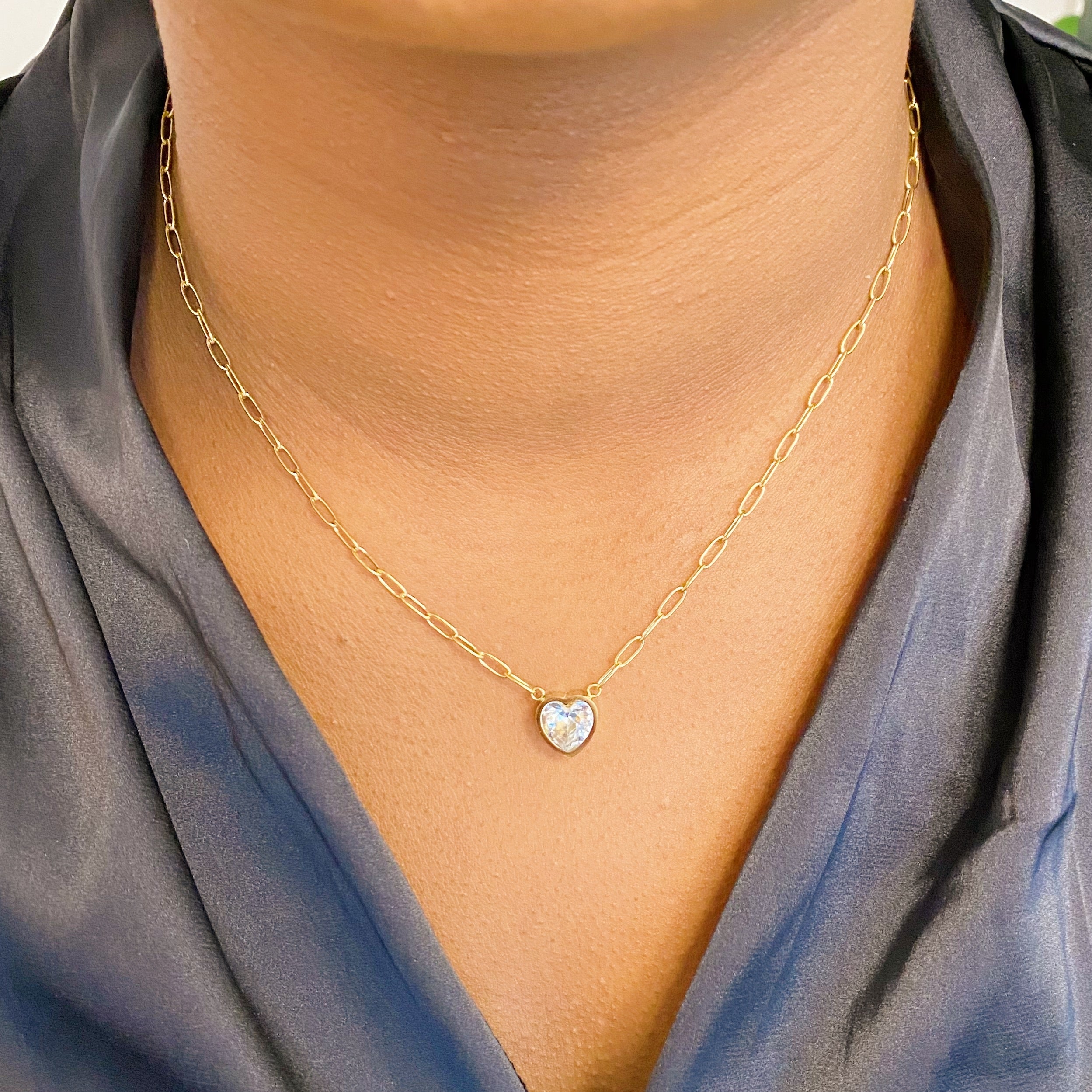 Chained To My Heart Necklace featuring a sparkly heart pendant and trendy link chain, showcasing its reversible design.