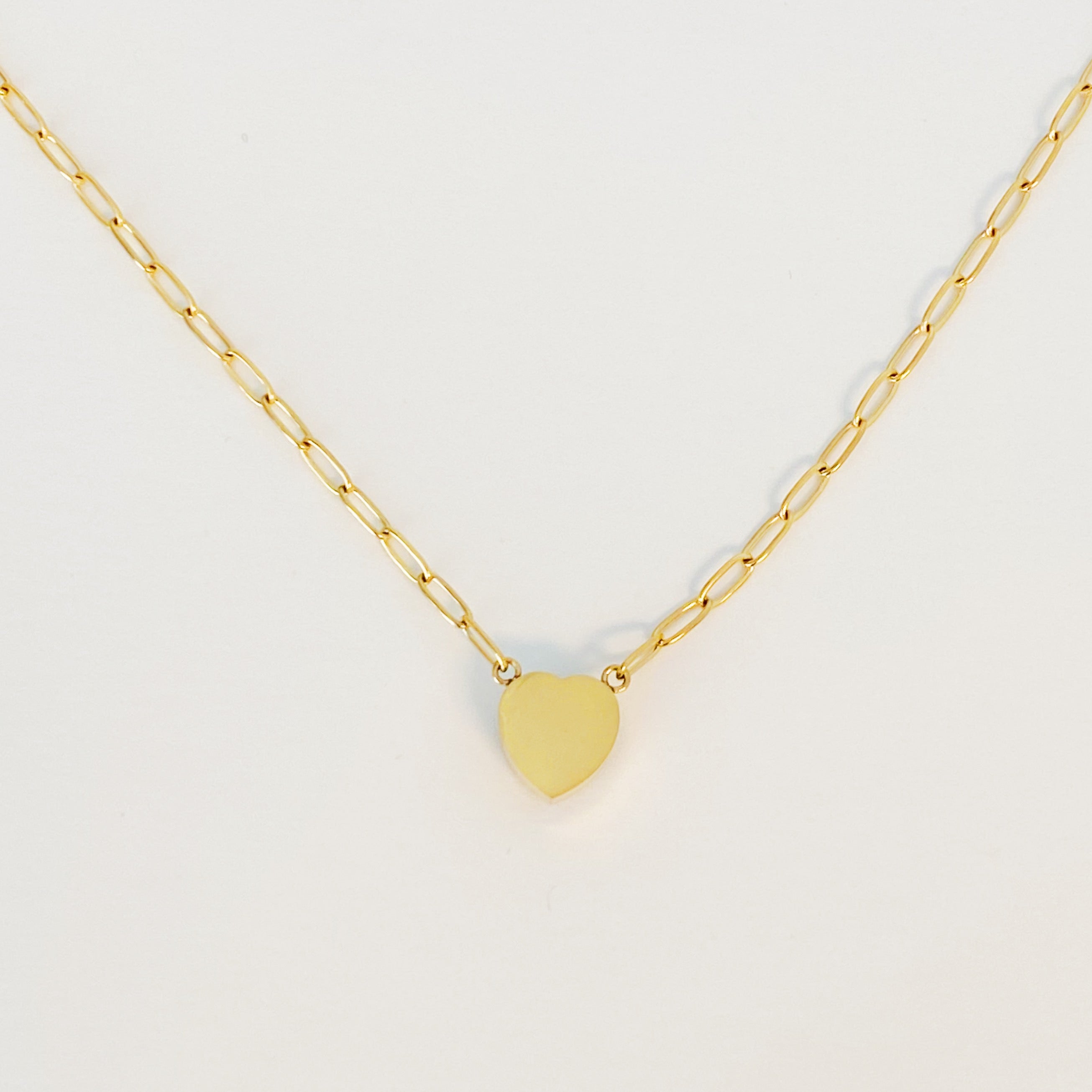 Chained To My Heart Necklace featuring a sparkly heart pendant and trendy link chain, showcasing its reversible design.