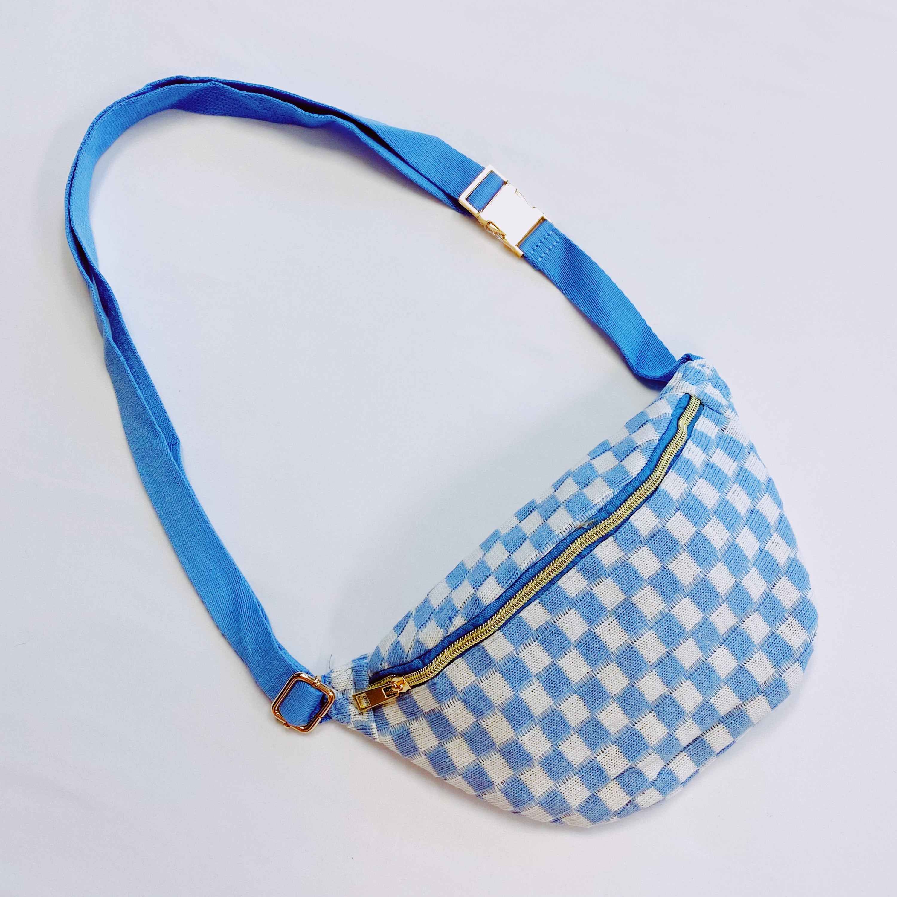 Check Yourself Belt Sling Bag featuring checkered knit material and gold-tone hardware, adjustable strap for comfort.