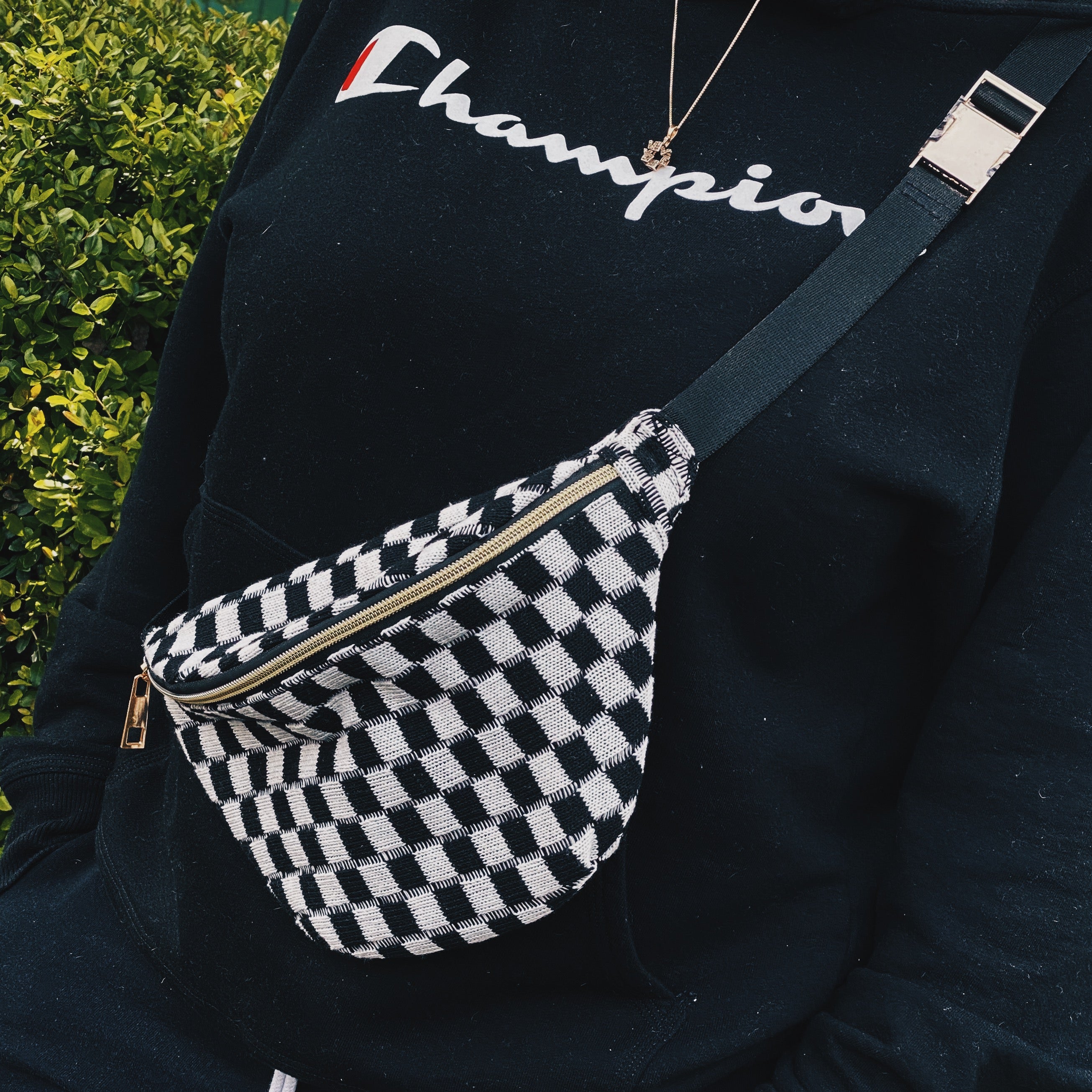 Check Yourself Belt Sling Bag featuring checkered knit material and gold-tone hardware, adjustable strap for comfort.