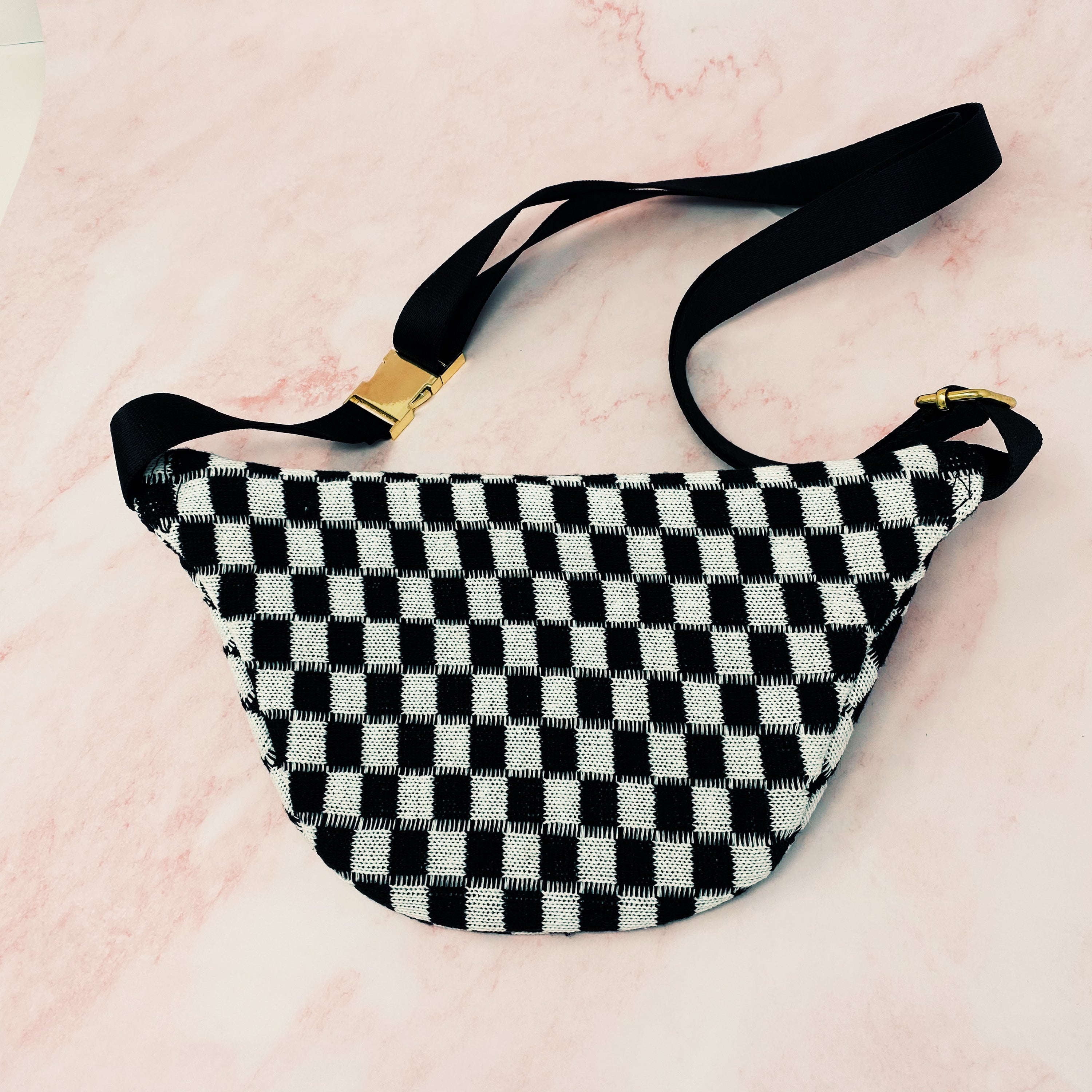 Check Yourself Belt Sling Bag featuring checkered knit material and gold-tone hardware, adjustable strap for comfort.