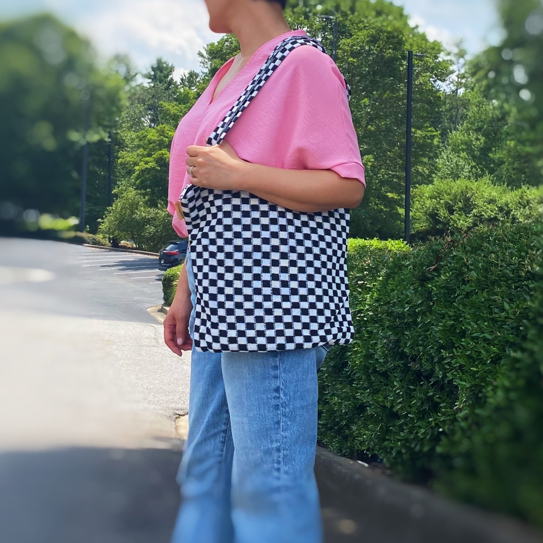 Check Yourself Zipped Tote Bag featuring a classic checkered pattern, secure zipper closure, and durable fabric straps.