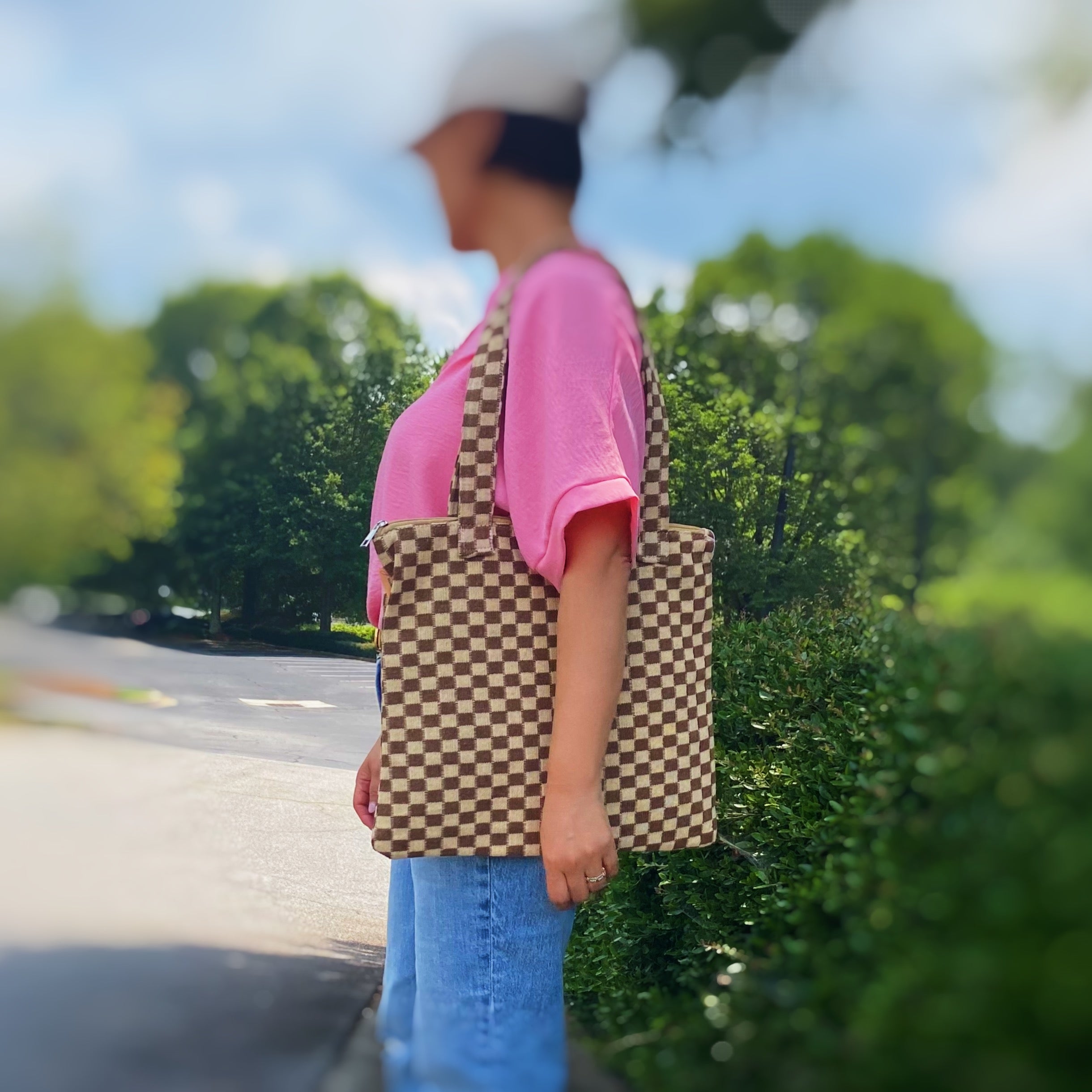 Check Yourself Zipped Tote Bag featuring a classic checkered pattern, secure zipper closure, and durable fabric straps.