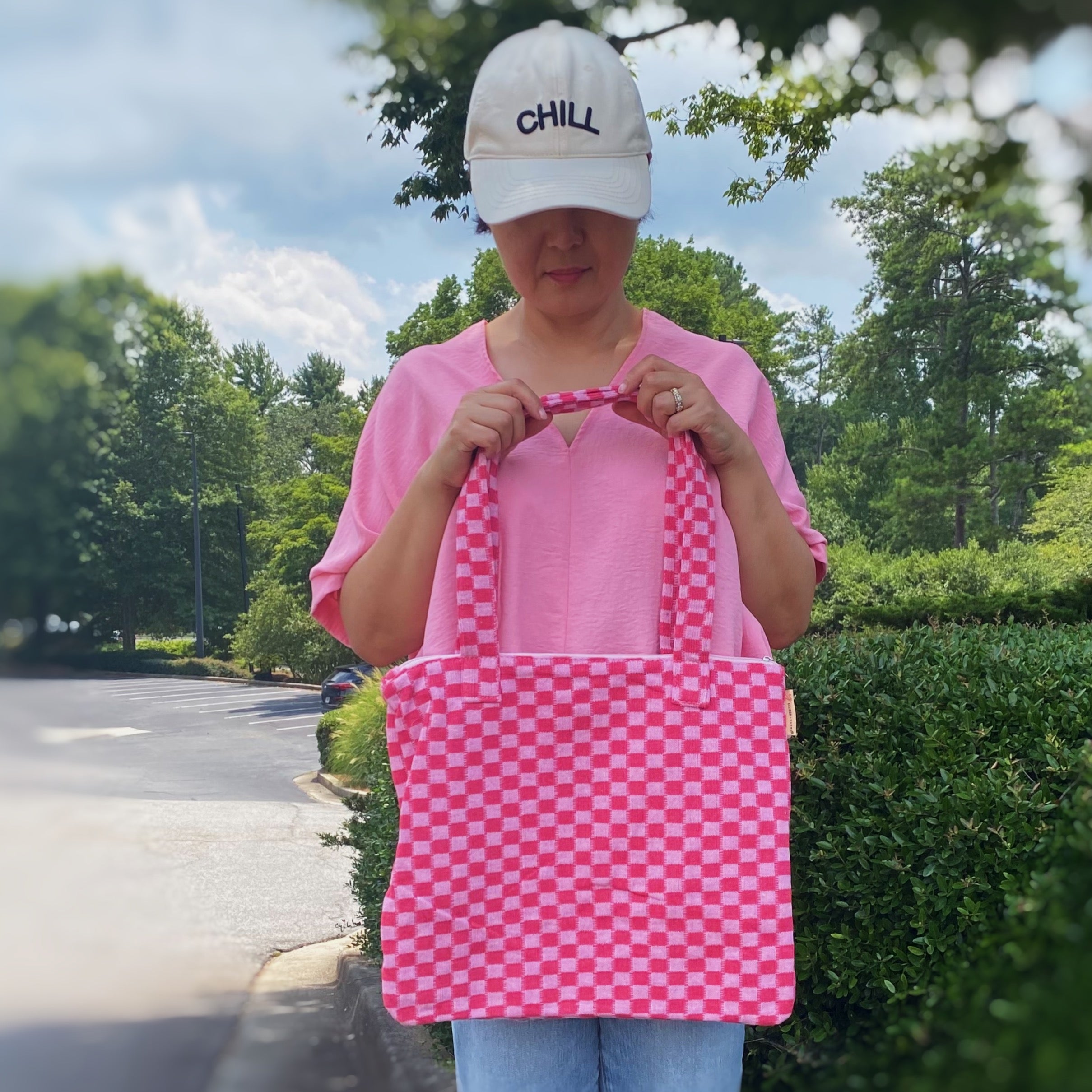 Check Yourself Zipped Tote Bag featuring a classic checkered pattern, secure zipper closure, and durable fabric straps.