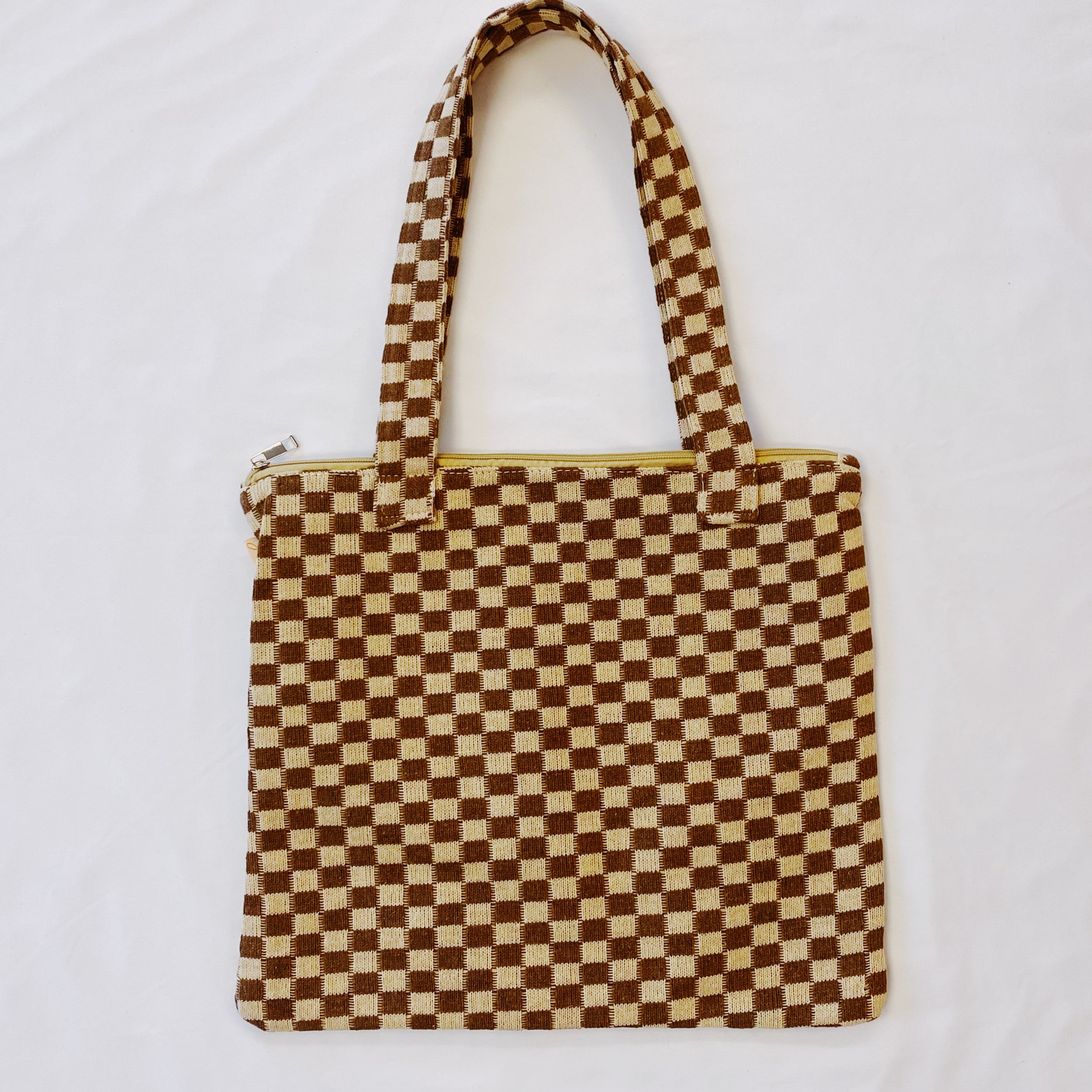 Check Yourself Zipped Tote Bag featuring a classic checkered pattern, secure zipper closure, and durable fabric straps.