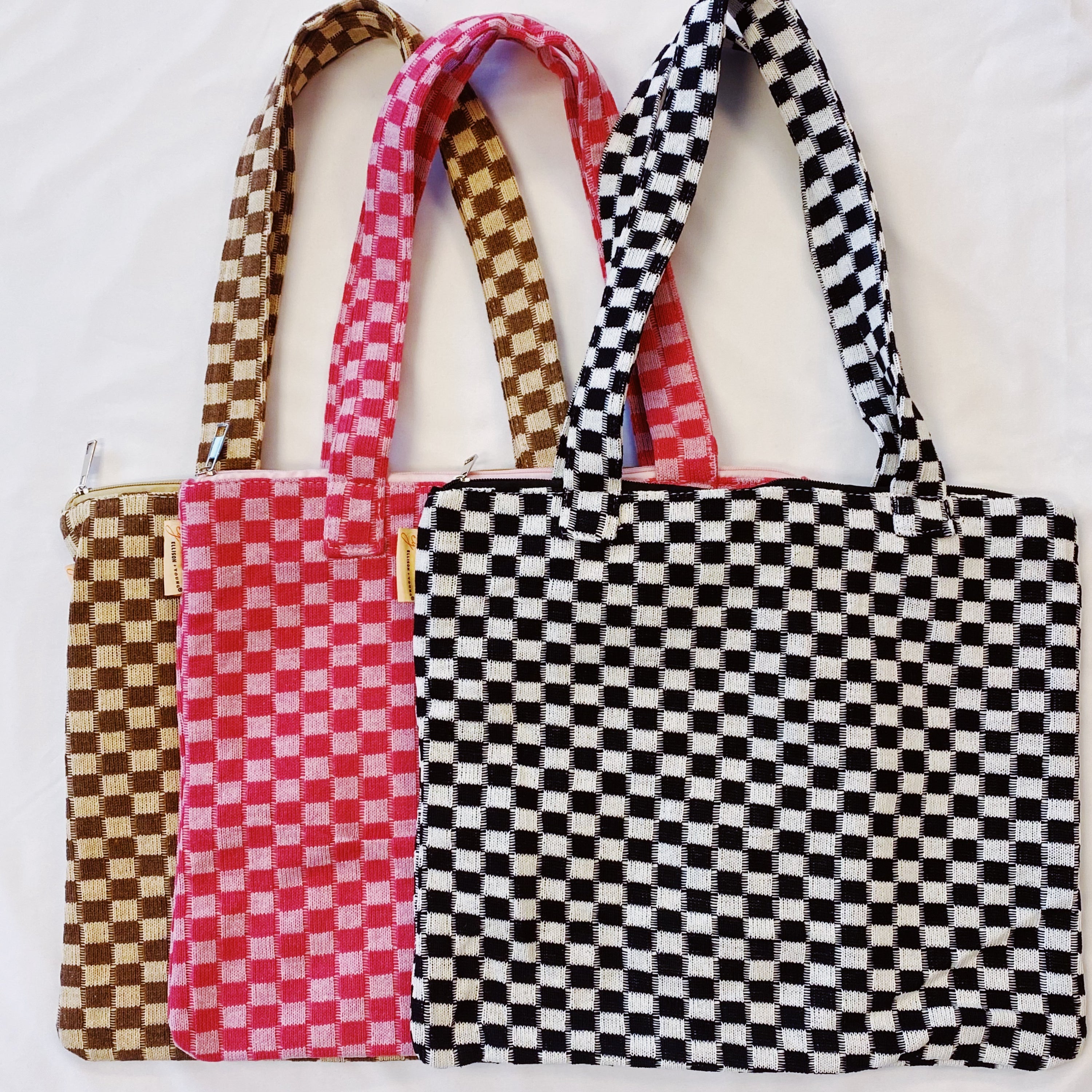 Check Yourself Zipped Tote Bag featuring a classic checkered pattern, secure zipper closure, and durable fabric straps.