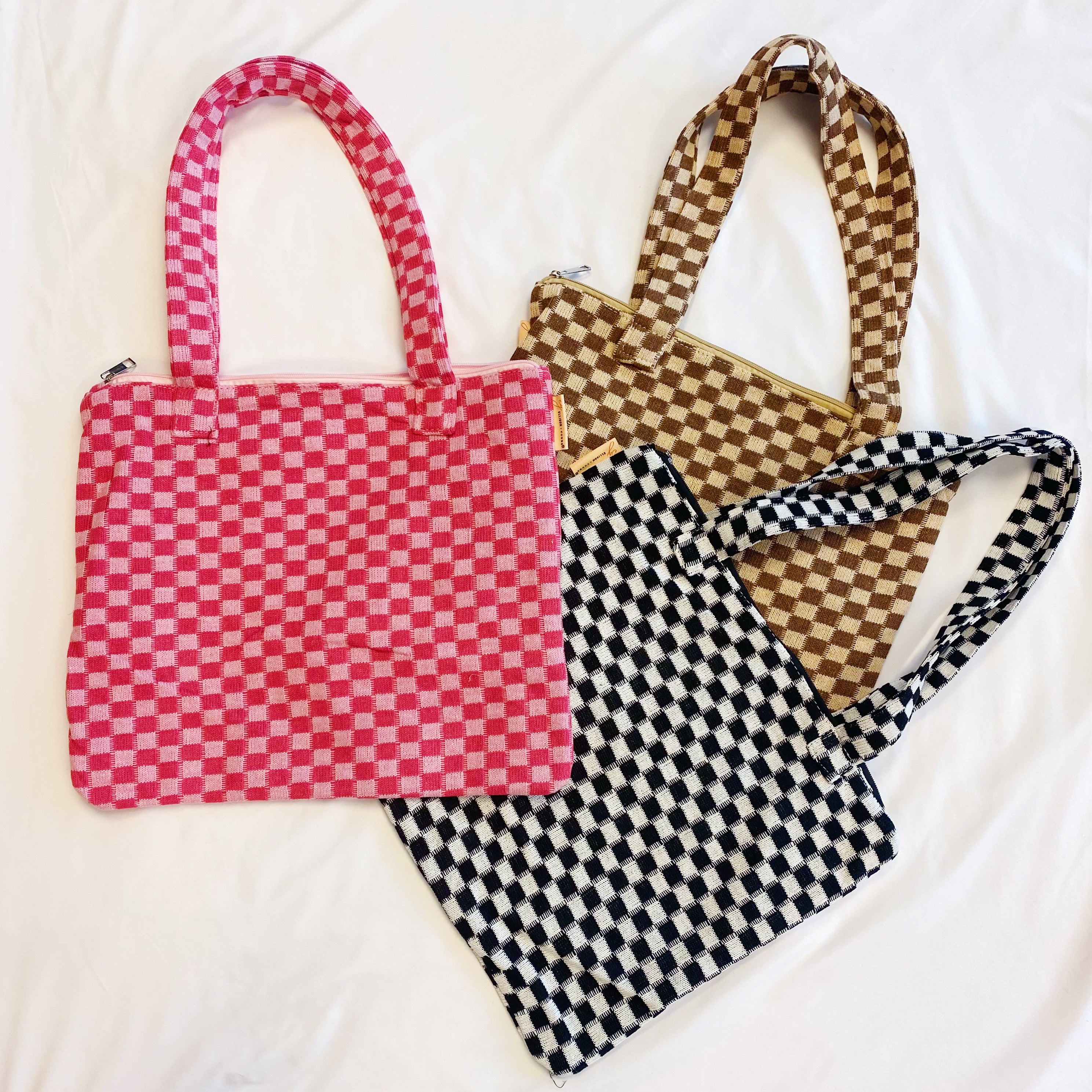 Check Yourself Zipped Tote Bag featuring a classic checkered pattern, secure zipper closure, and durable fabric straps.