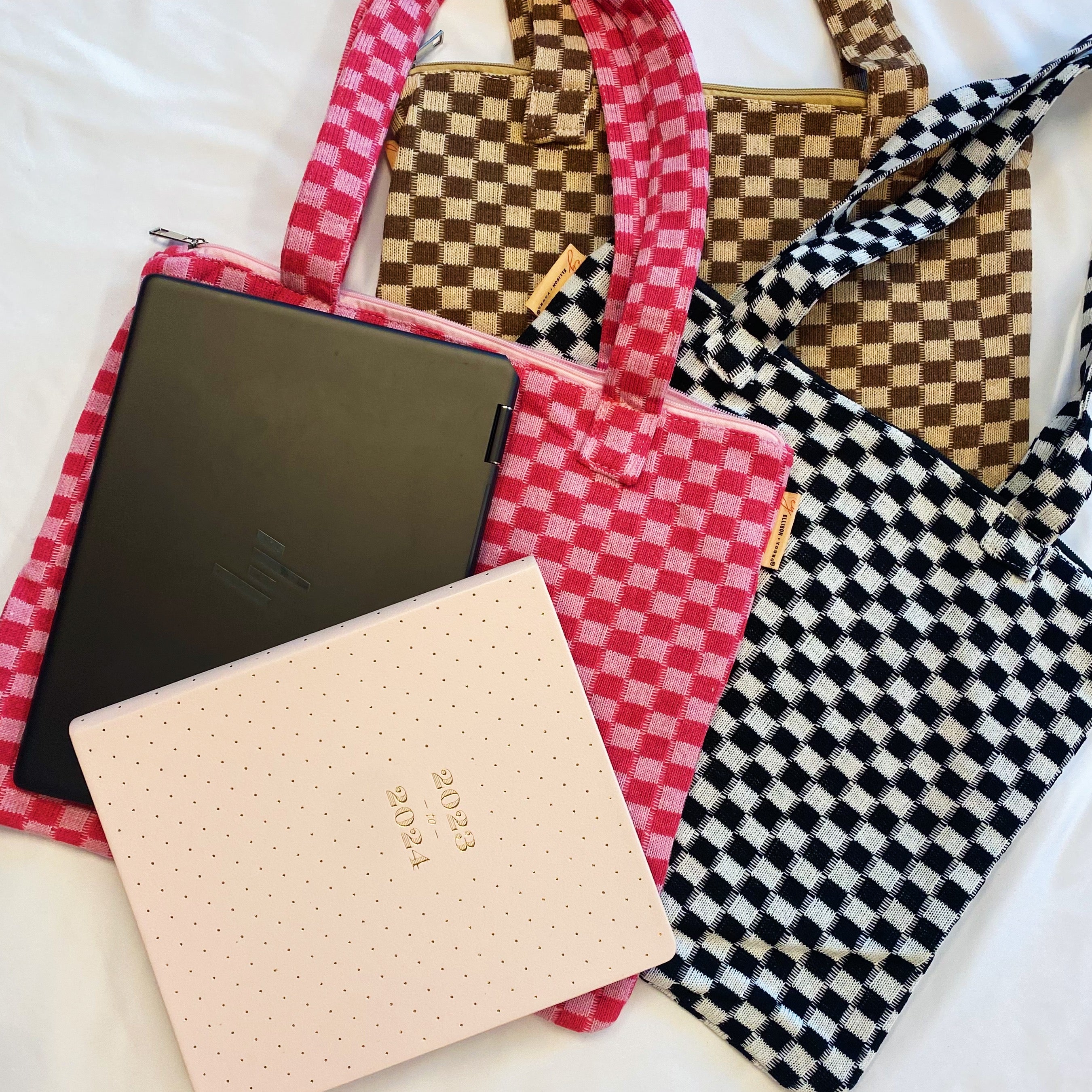 Check Yourself Zipped Tote Bag featuring a classic checkered pattern, secure zipper closure, and durable fabric straps.