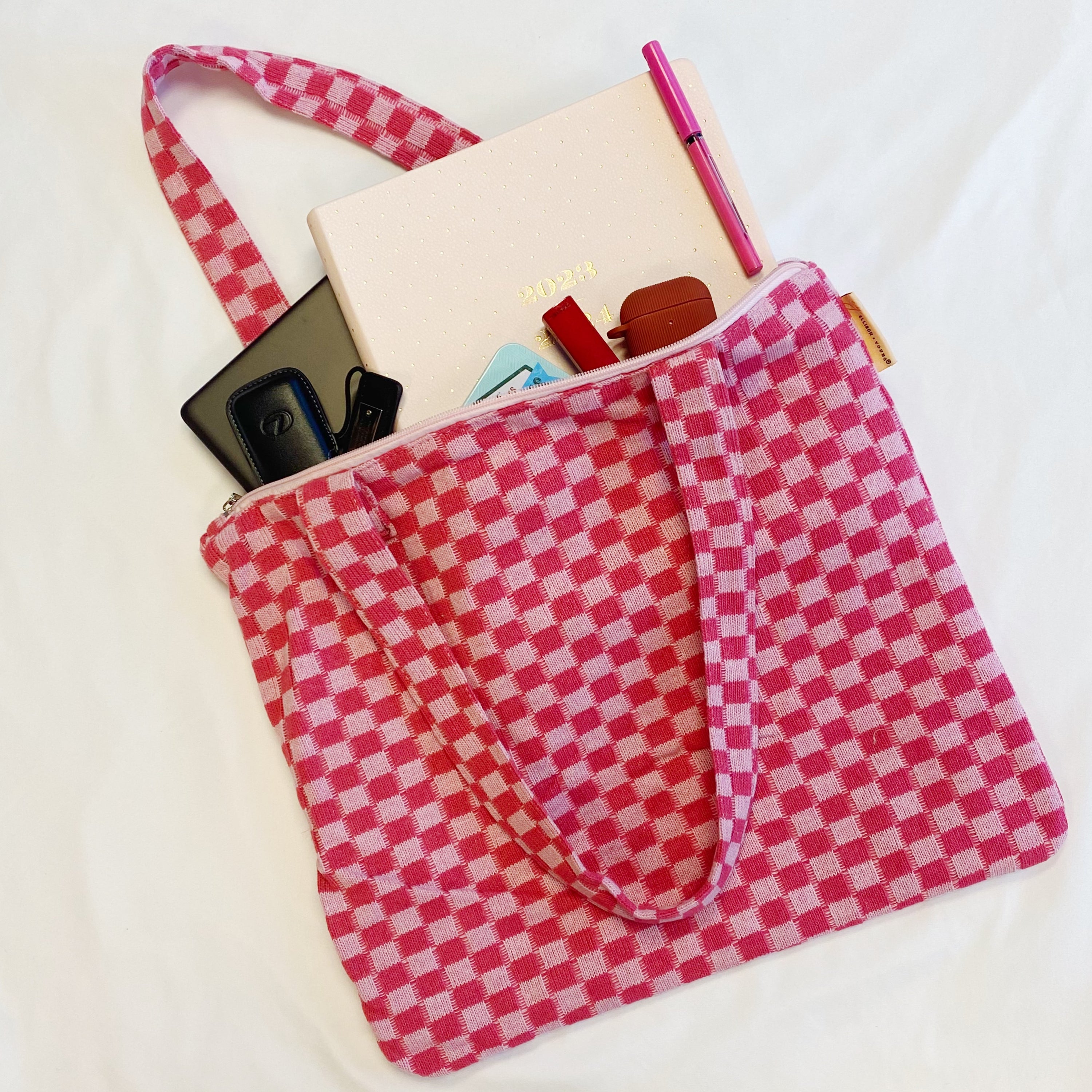 Check Yourself Zipped Tote Bag featuring a classic checkered pattern, secure zipper closure, and durable fabric straps.