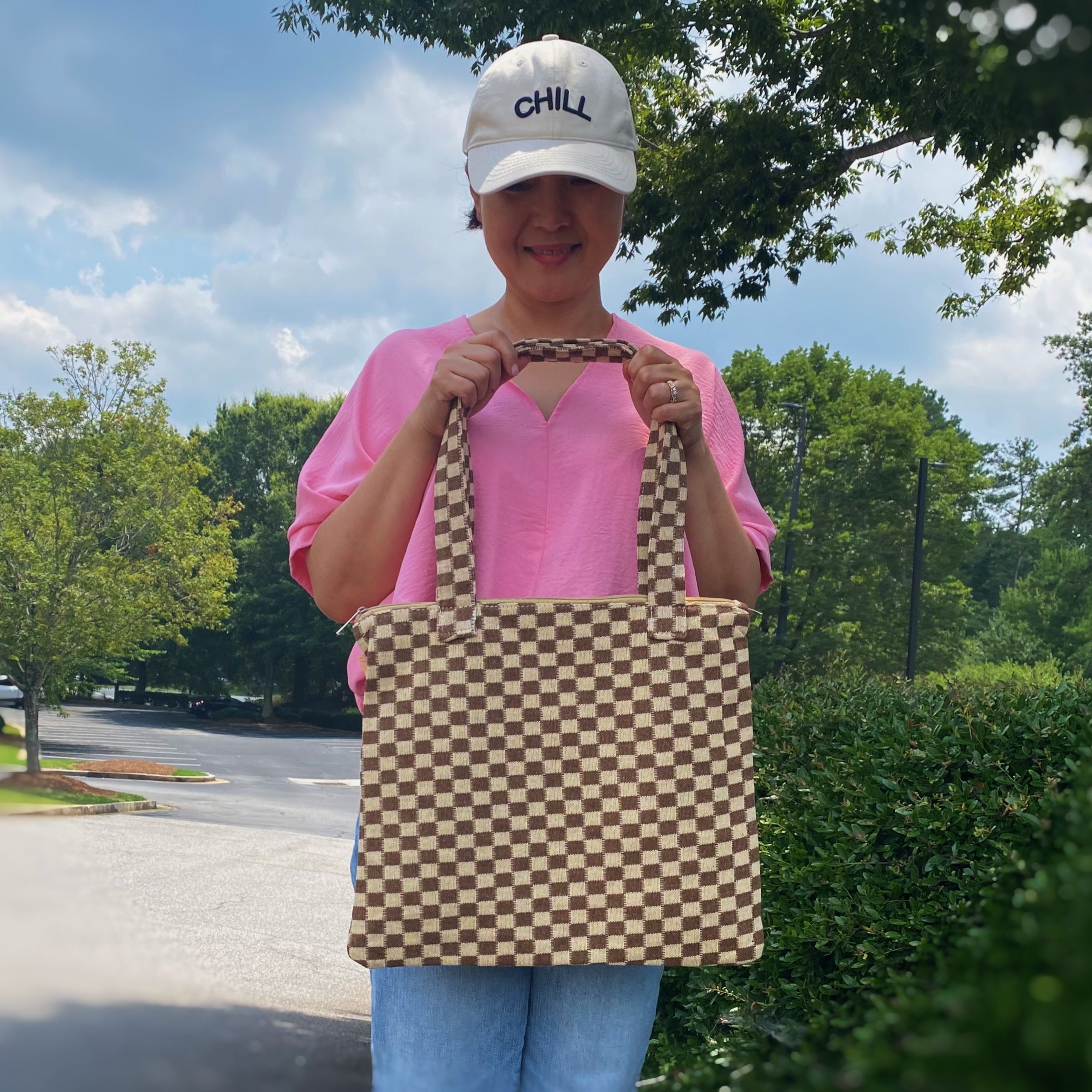 Check Yourself Zipped Tote Bag featuring a classic checkered pattern, secure zipper closure, and durable fabric straps.