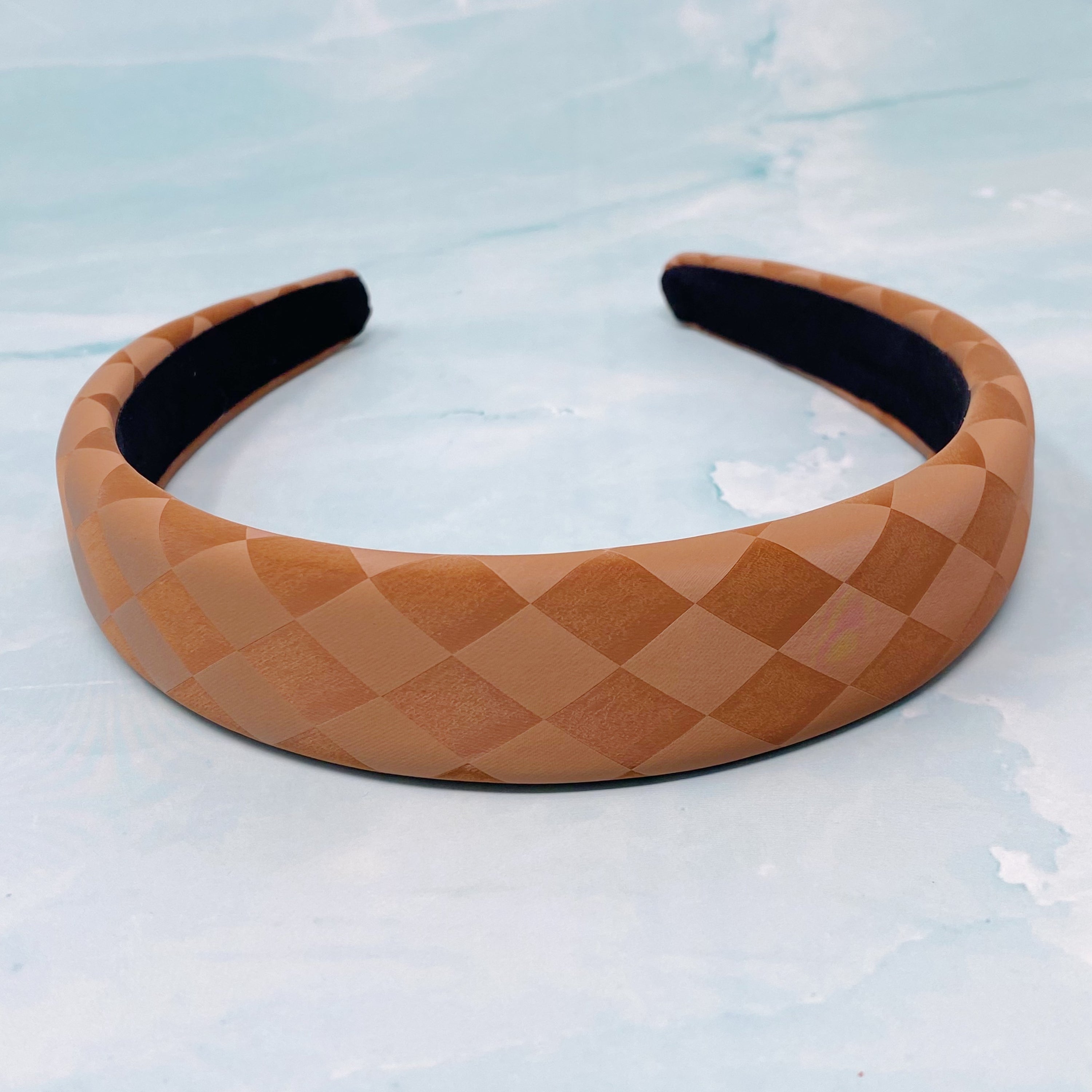 Checked In Mute Headband featuring a stylish checkered diamond pattern in muted tones, designed for comfort and all-day wear.