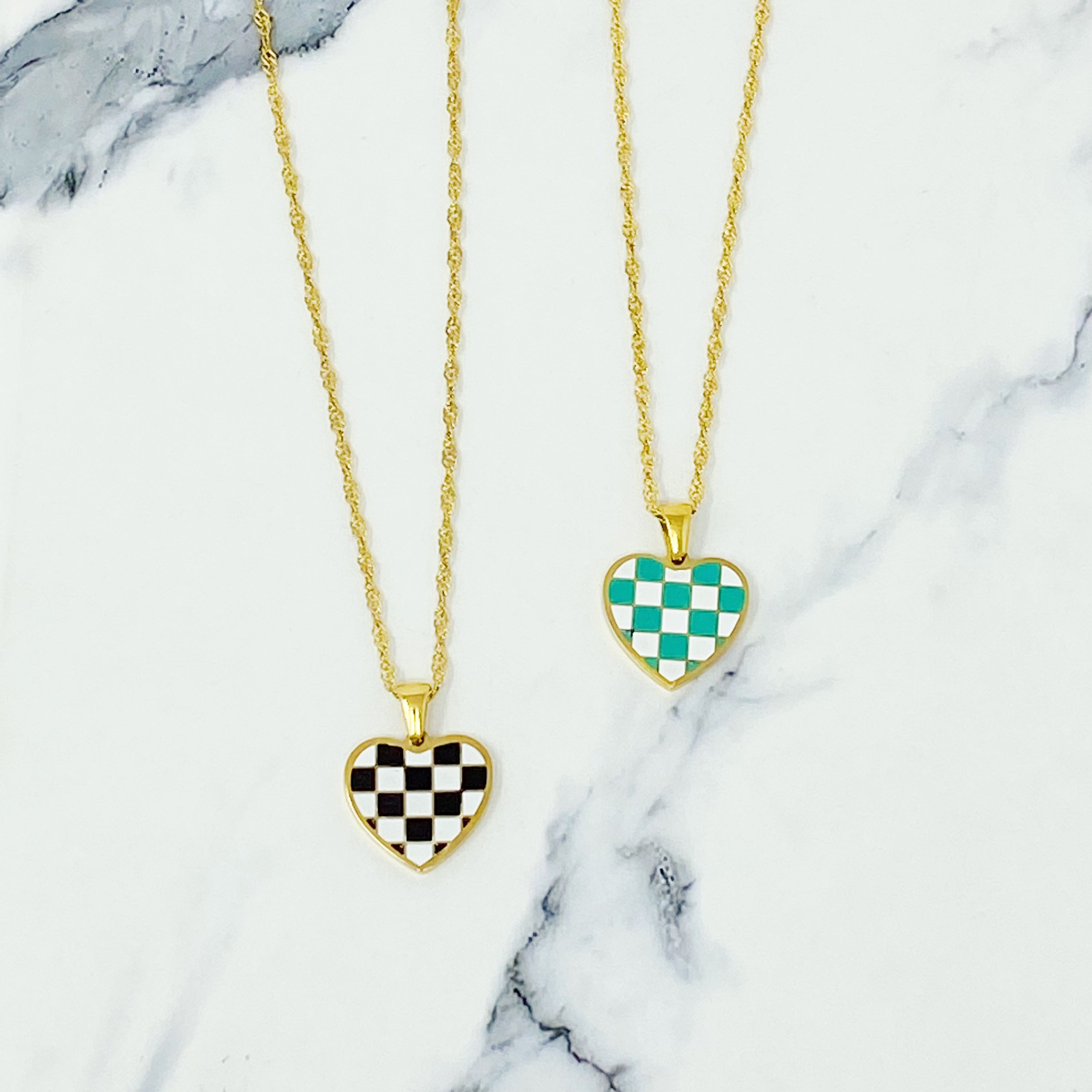 Checkered Heart Necklace featuring a unique heart pendant with a checkerboard pattern and a polished back, set on a gold plated chain.