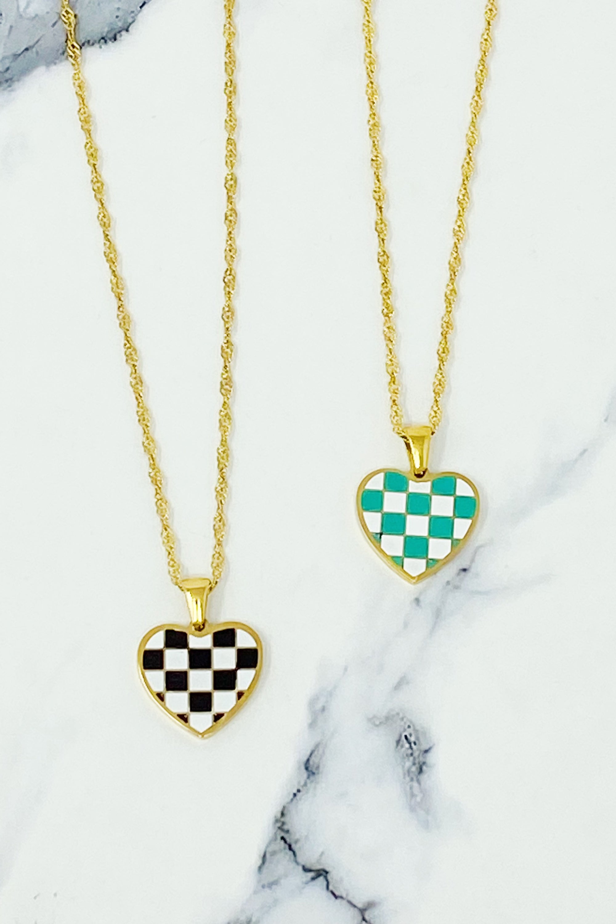 Checkered Heart Necklace featuring a unique heart pendant with a checkerboard pattern and a polished back, set on a gold plated chain.