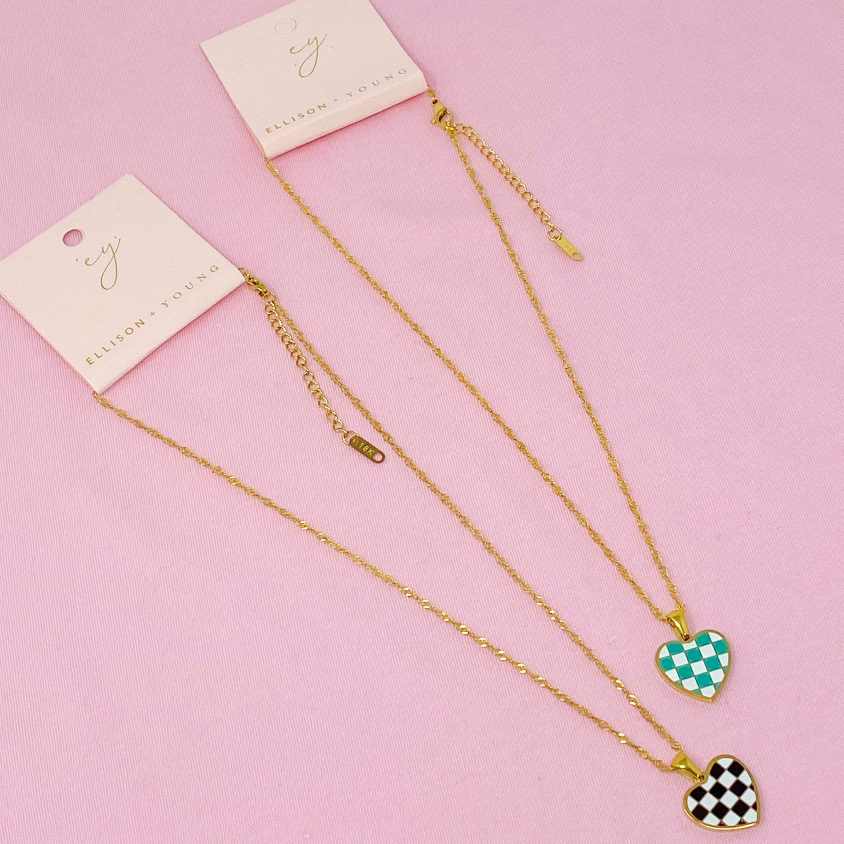 Checkered Heart Necklace featuring a unique heart pendant with a checkerboard pattern and a polished back, set on a gold plated chain.