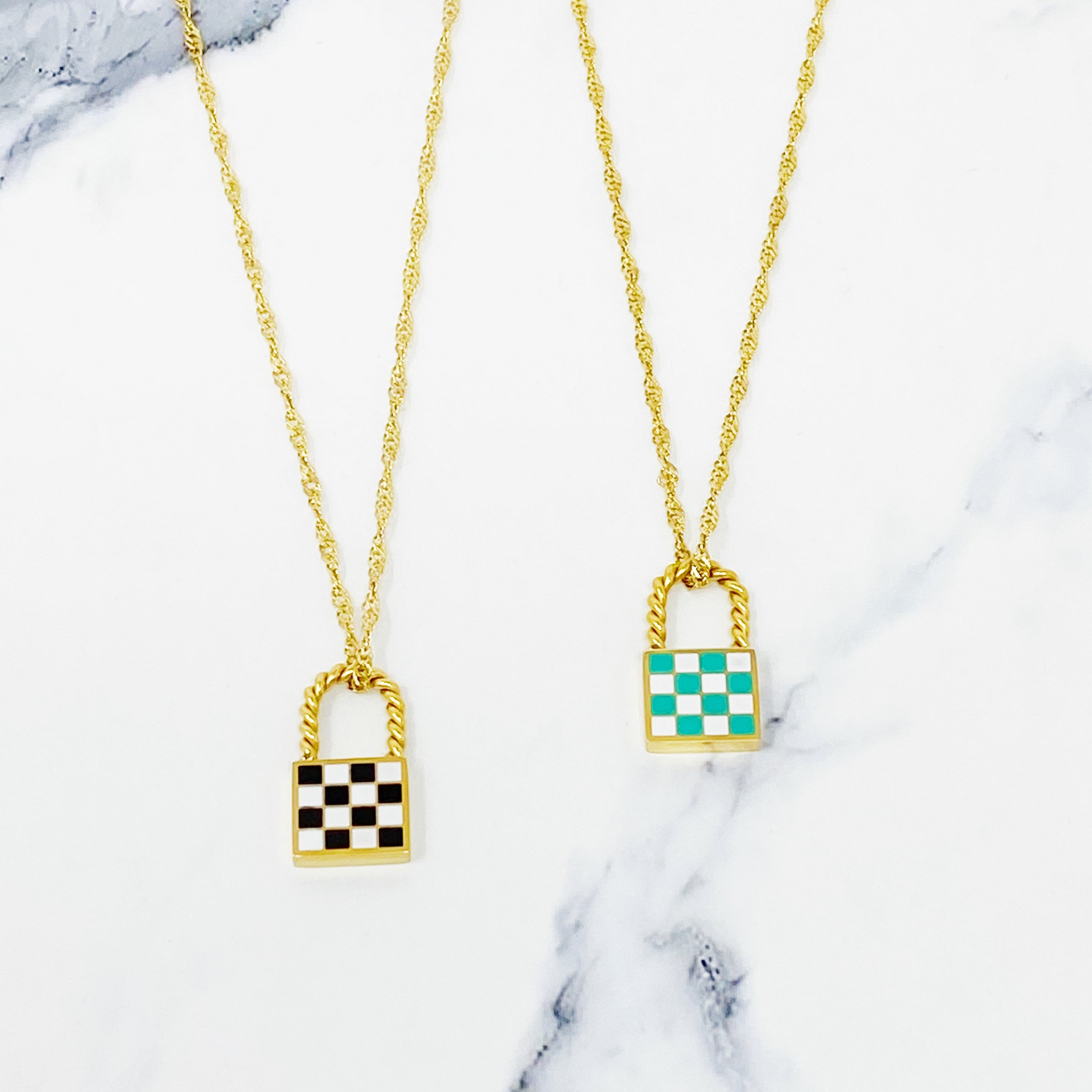 A stylish checkered locket necklace featuring a unique checkerboard pattern on the front and a polished back, hanging from a classy twist chain.