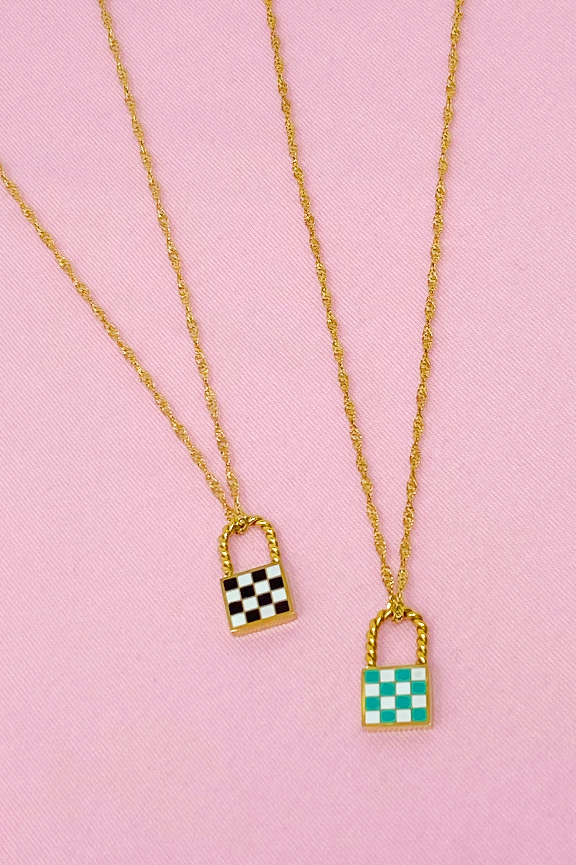 A stylish checkered locket necklace featuring a unique checkerboard pattern on the front and a polished back, hanging from a classy twist chain.