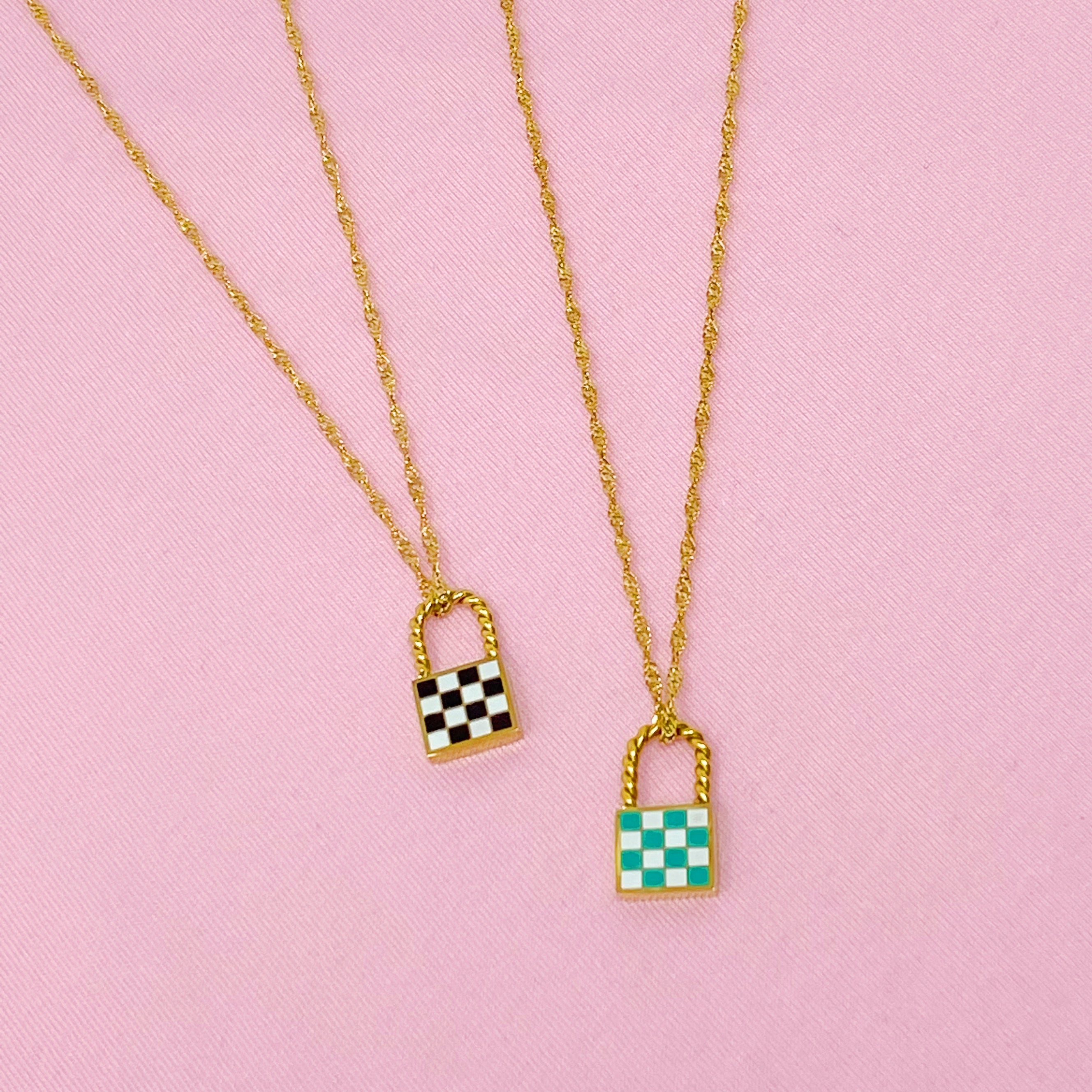 A stylish checkered locket necklace featuring a unique checkerboard pattern on the front and a polished back, hanging from a classy twist chain.