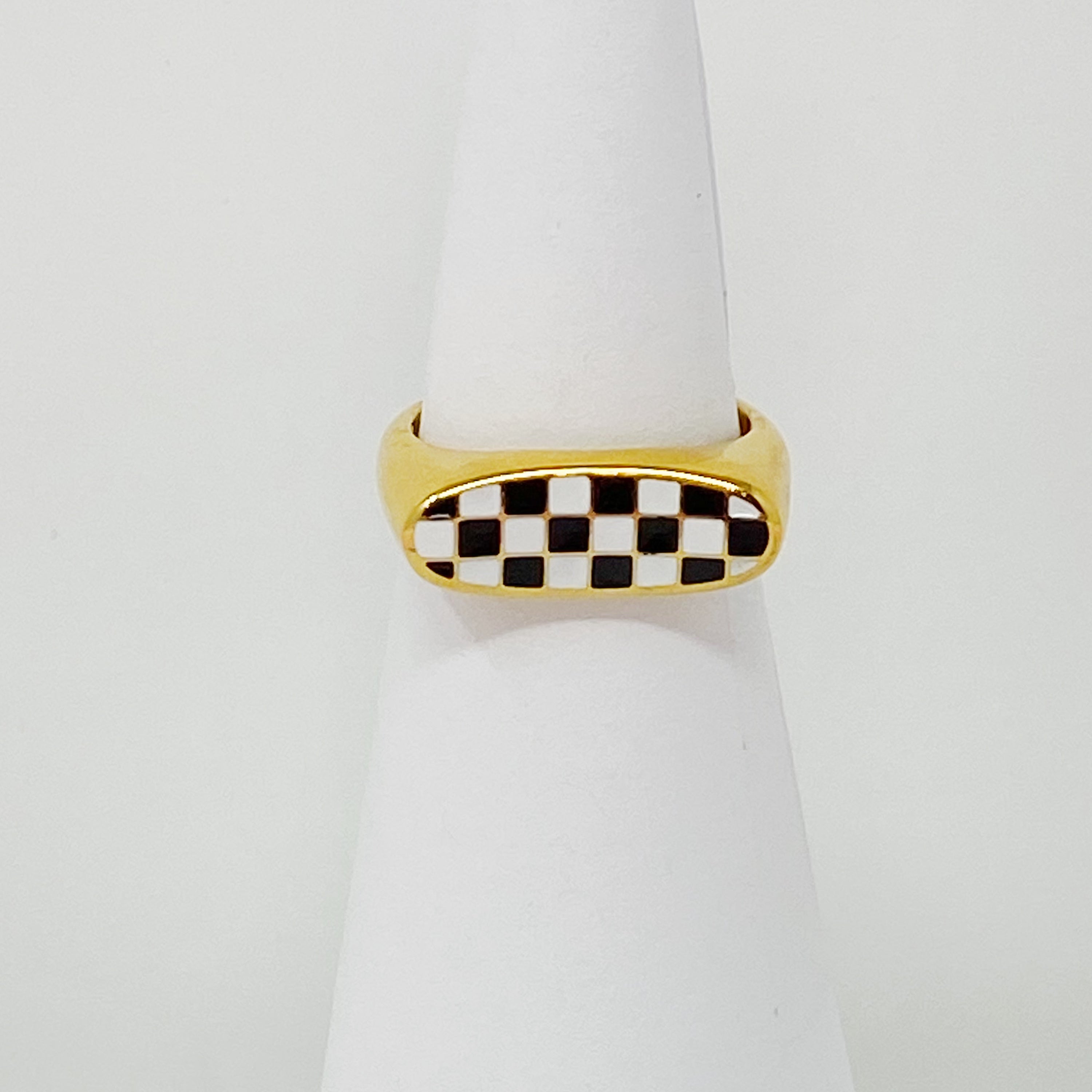 Checkered Oblong Ring featuring a unique curved shape and polished finish, crafted from 18K gold-plated stainless steel.