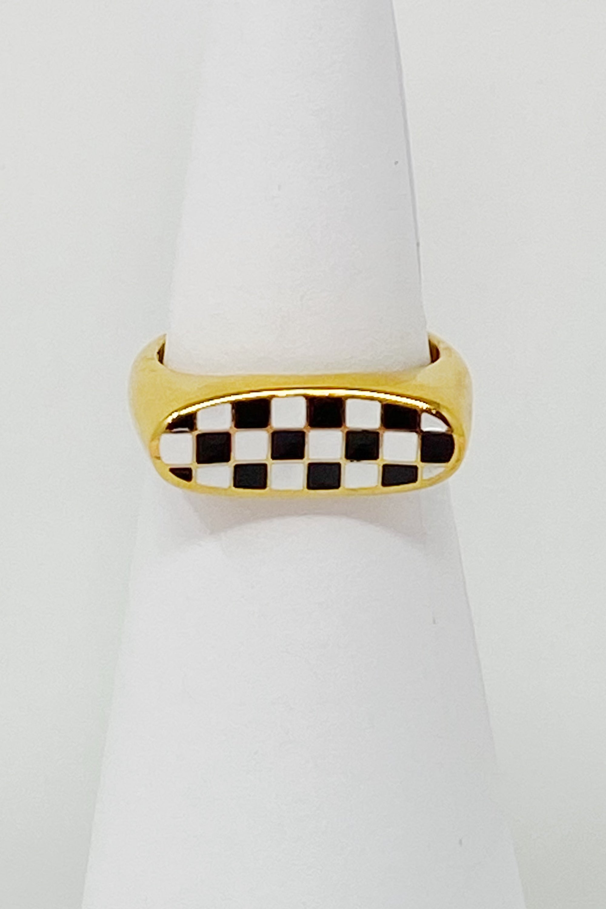 Checkered Oblong Ring featuring a unique curved shape and polished finish, crafted from 18K gold-plated stainless steel.