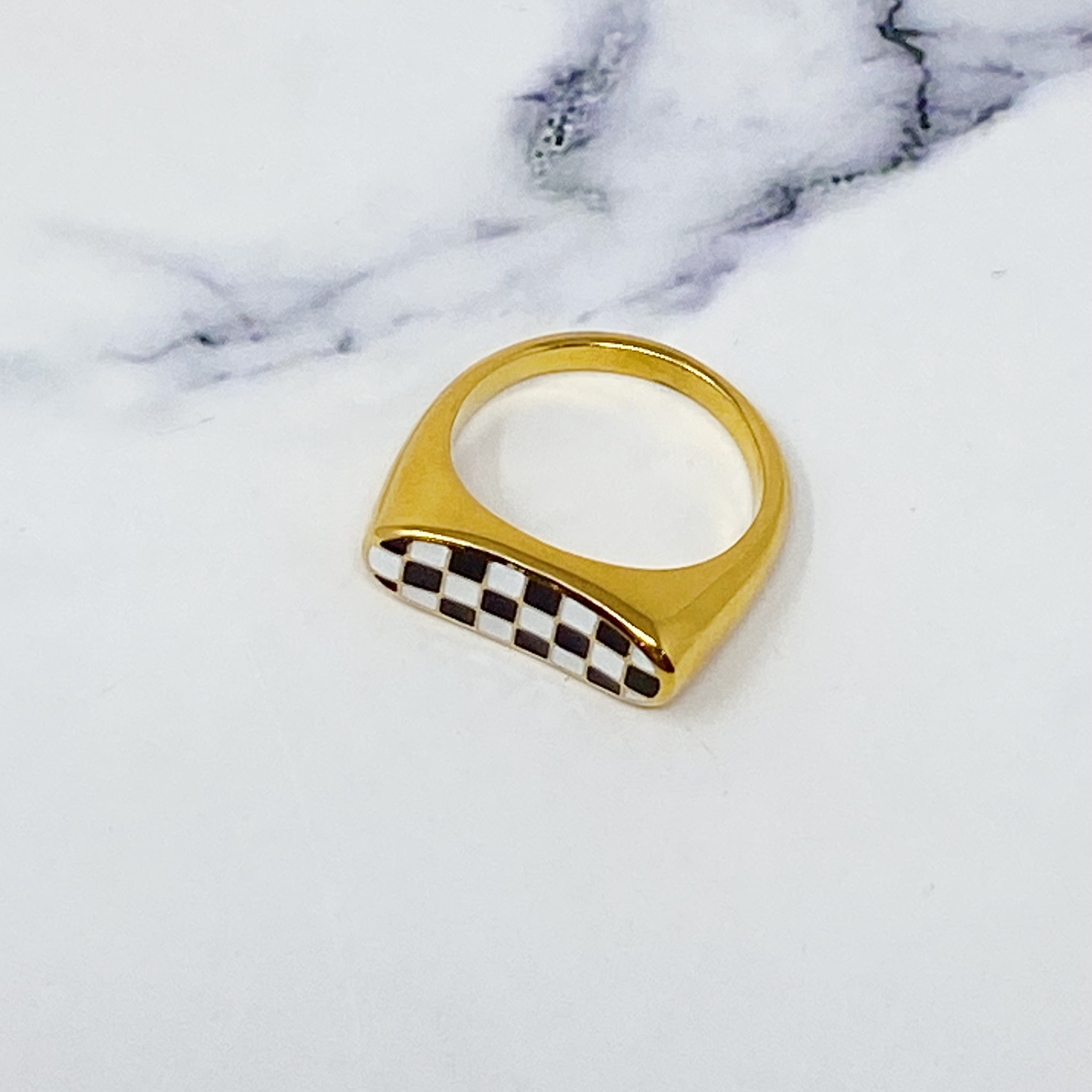 Checkered Oblong Ring featuring a unique curved shape and polished finish, crafted from 18K gold-plated stainless steel.