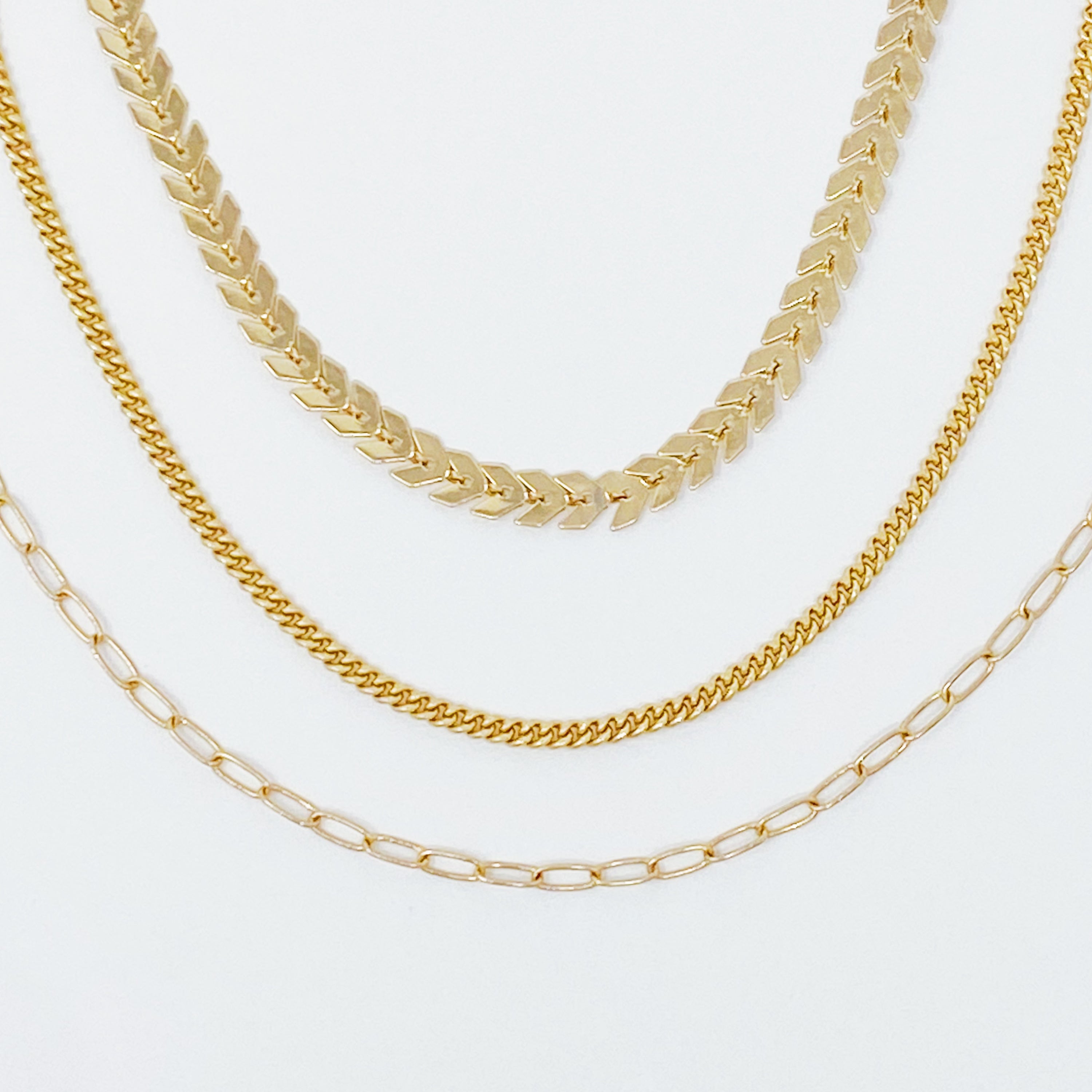 Set of 3 Chevron Chain Anklets in gold and silver plating, showcasing trendy layered design.