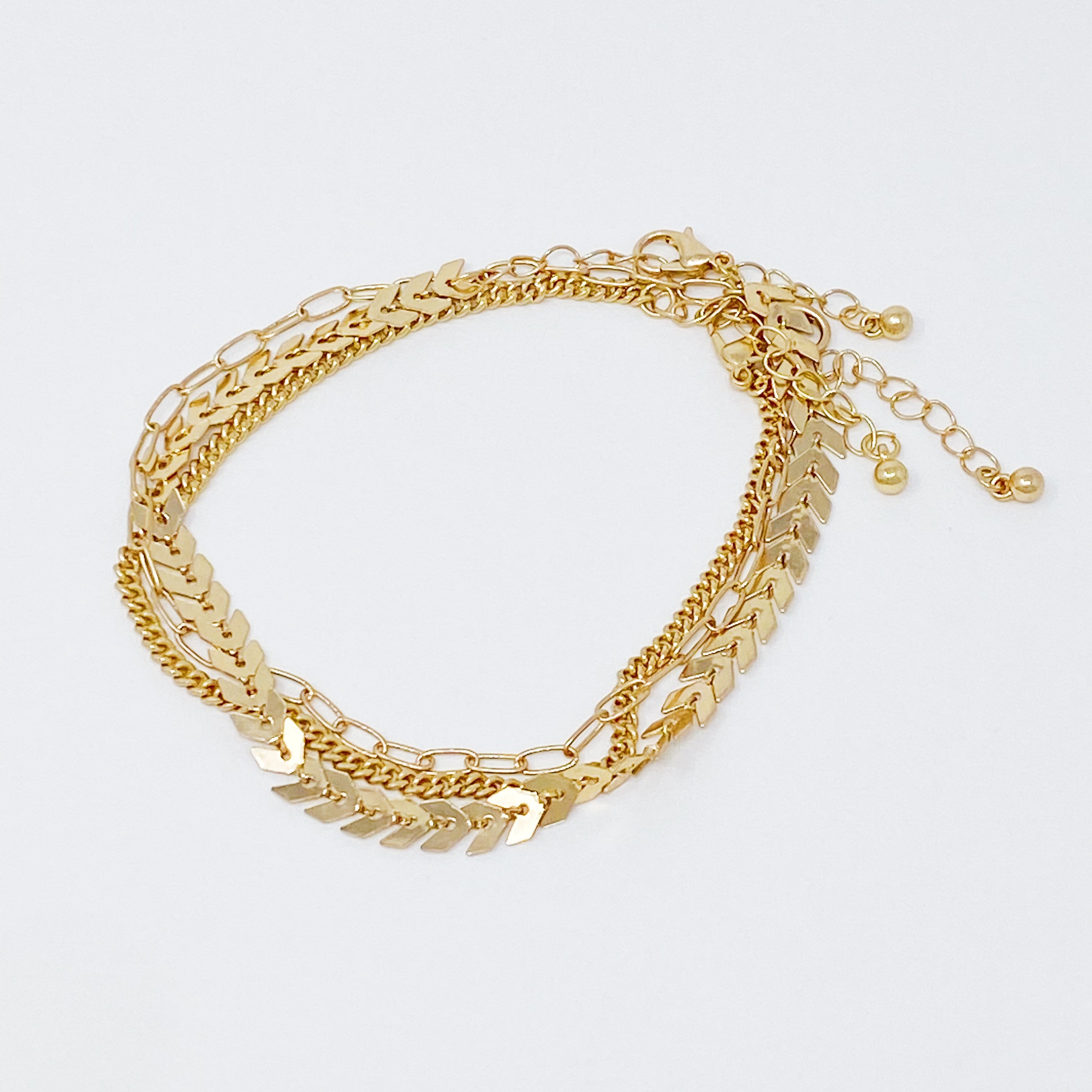 Set of 3 Chevron Chain Anklets in gold and silver plating, showcasing trendy layered design.