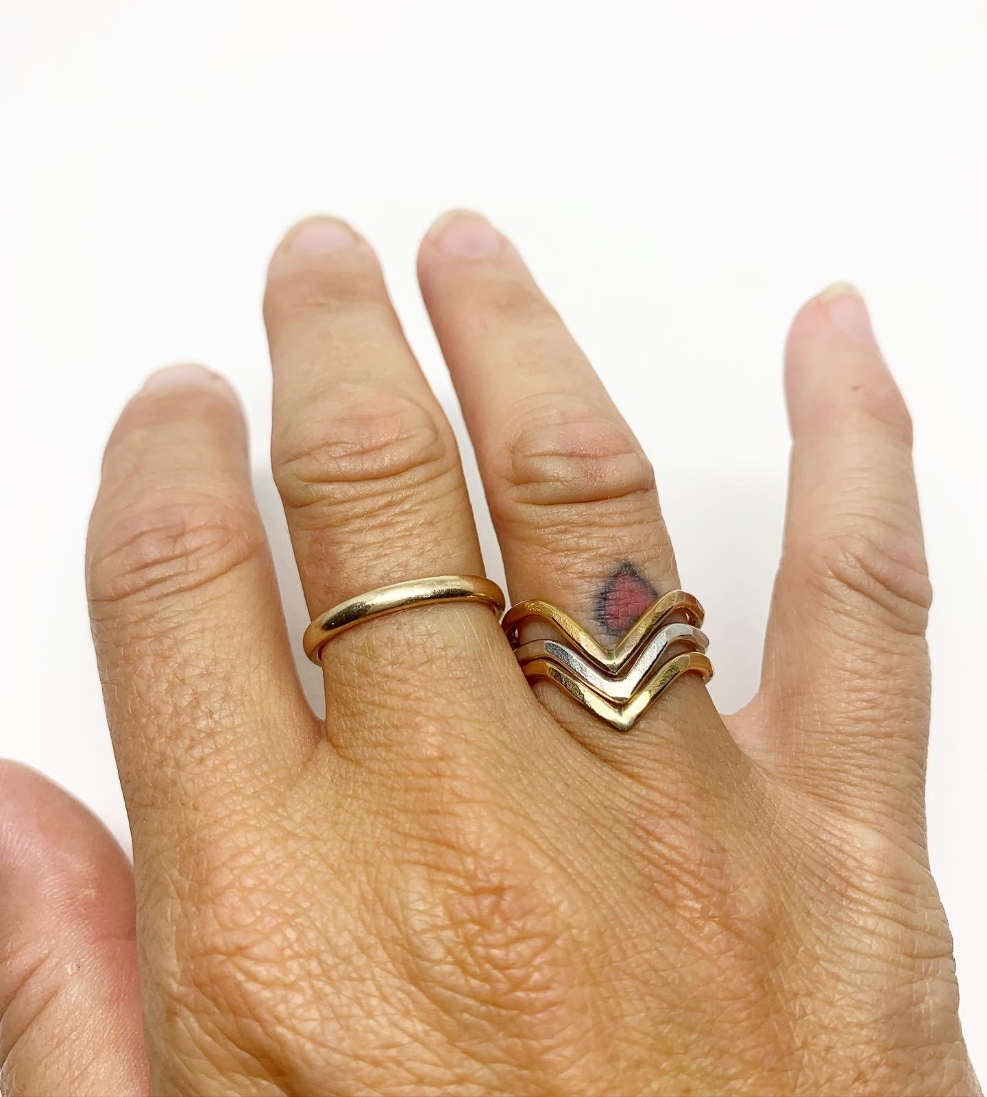 Chevron Stacking Ring in sterling silver, yellow gold fill, and rose gold fill, showcasing a textured, hammered finish.