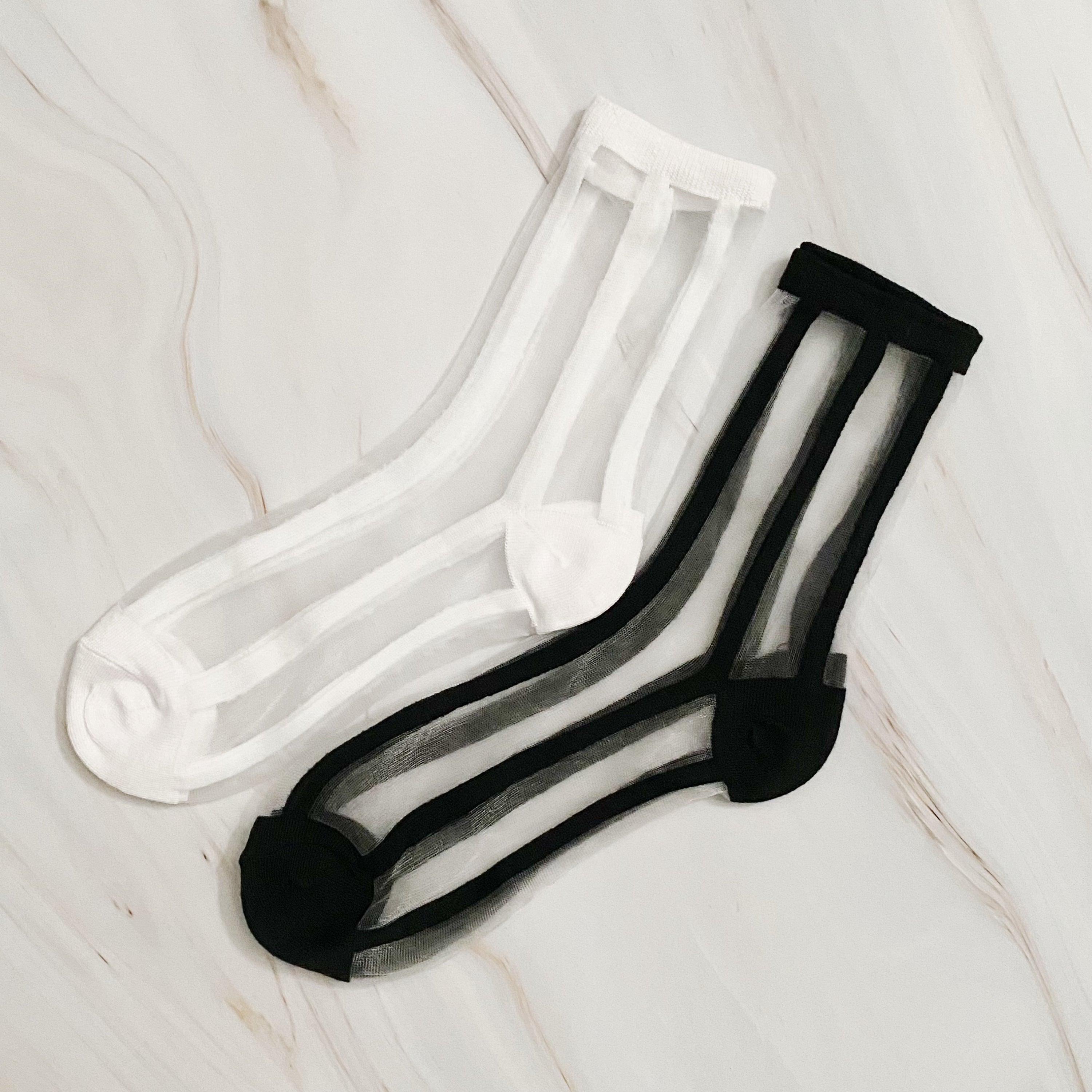 Chic In Line sheer socks set of 2 pairs in black and white striped pattern, showcasing their lightweight and stylish design.