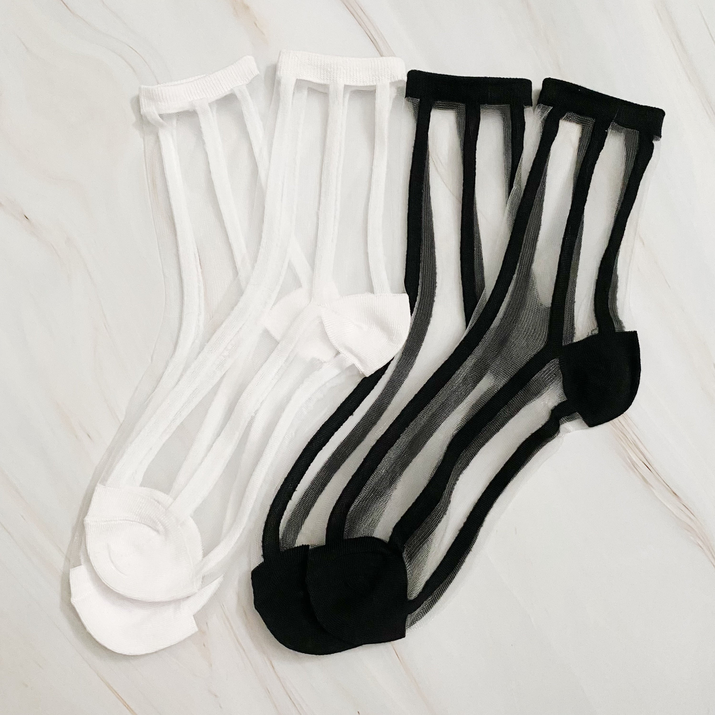 Chic In Line sheer socks set of 2 pairs in black and white striped pattern, showcasing their lightweight and stylish design.