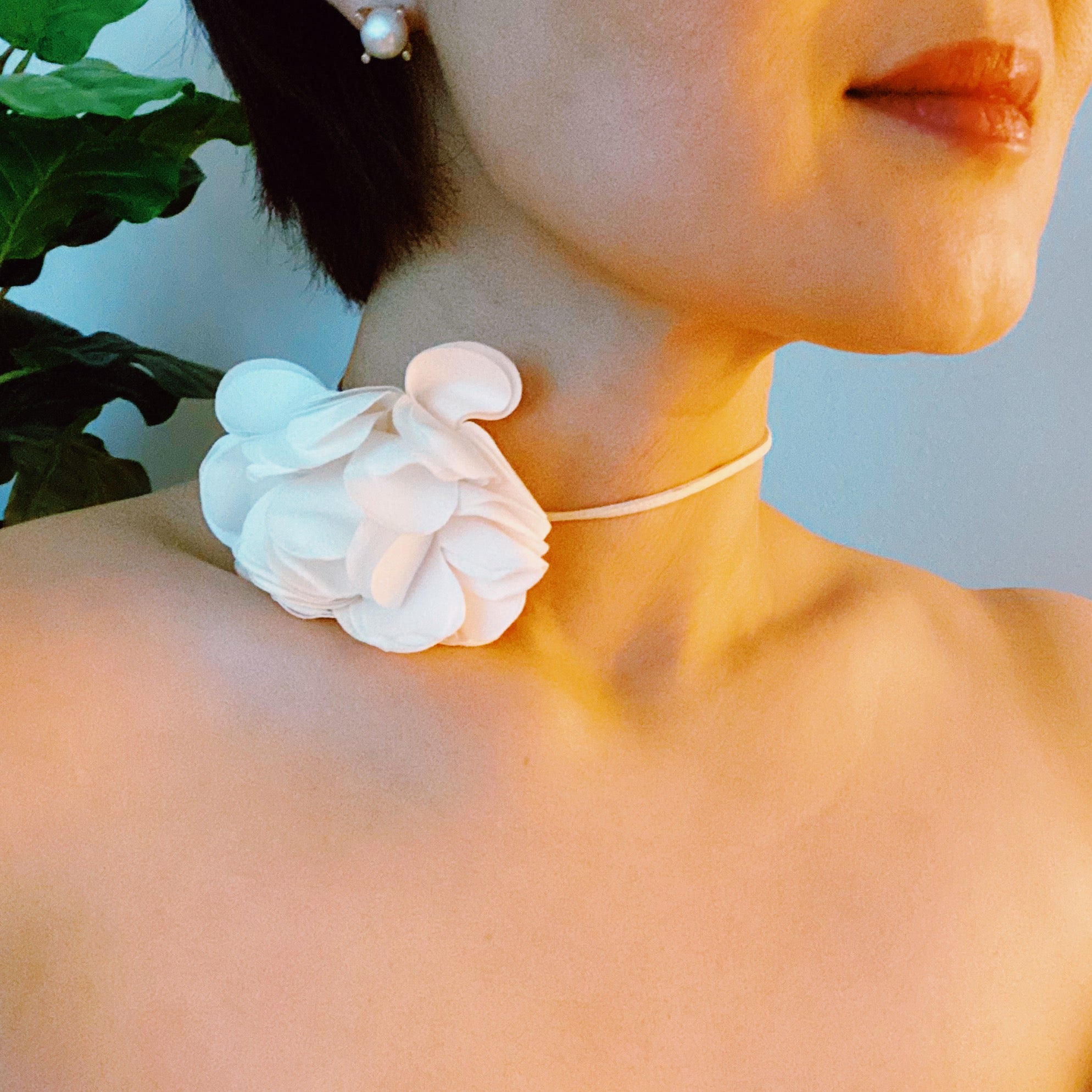 Chiffon Petals Rosette Tie necklace featuring a delicate fabric flower and a long slim strap, showcasing its versatility and lightweight design.