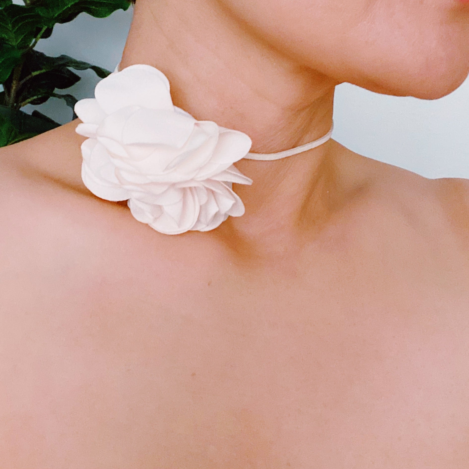 Chiffon Petals Rosette Tie necklace featuring a delicate fabric flower and a long slim strap, showcasing its versatility and lightweight design.