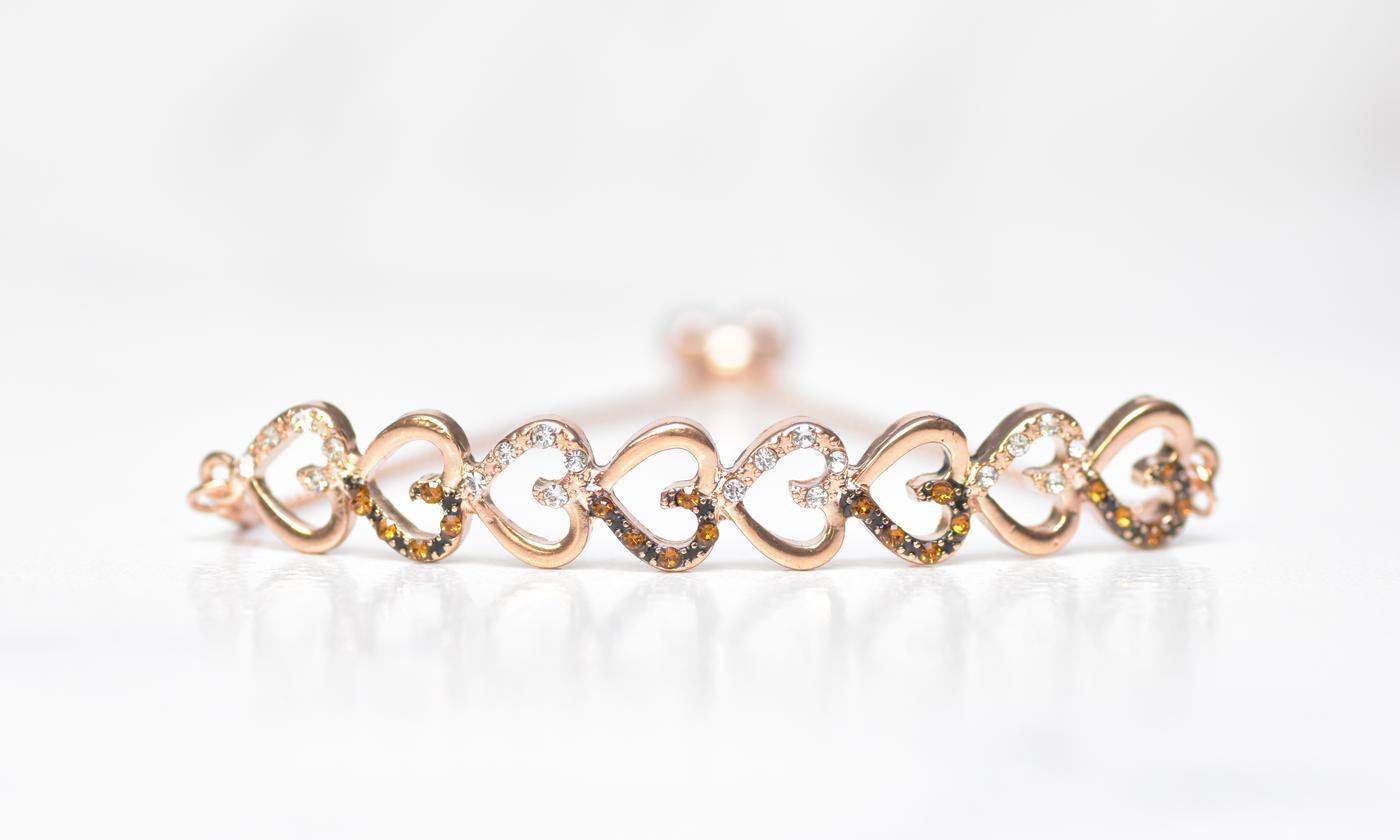 Chocolate toned bar bracelet featuring 14K rose gold plating, elegant link chain, and pull-clasp design.