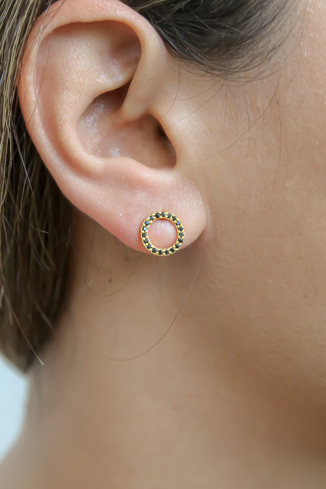 Elegant 18K gold-plated circle earrings adorned with sparkling zirconia stones, designed for pierced ears and hypoallergenic for sensitive skin.