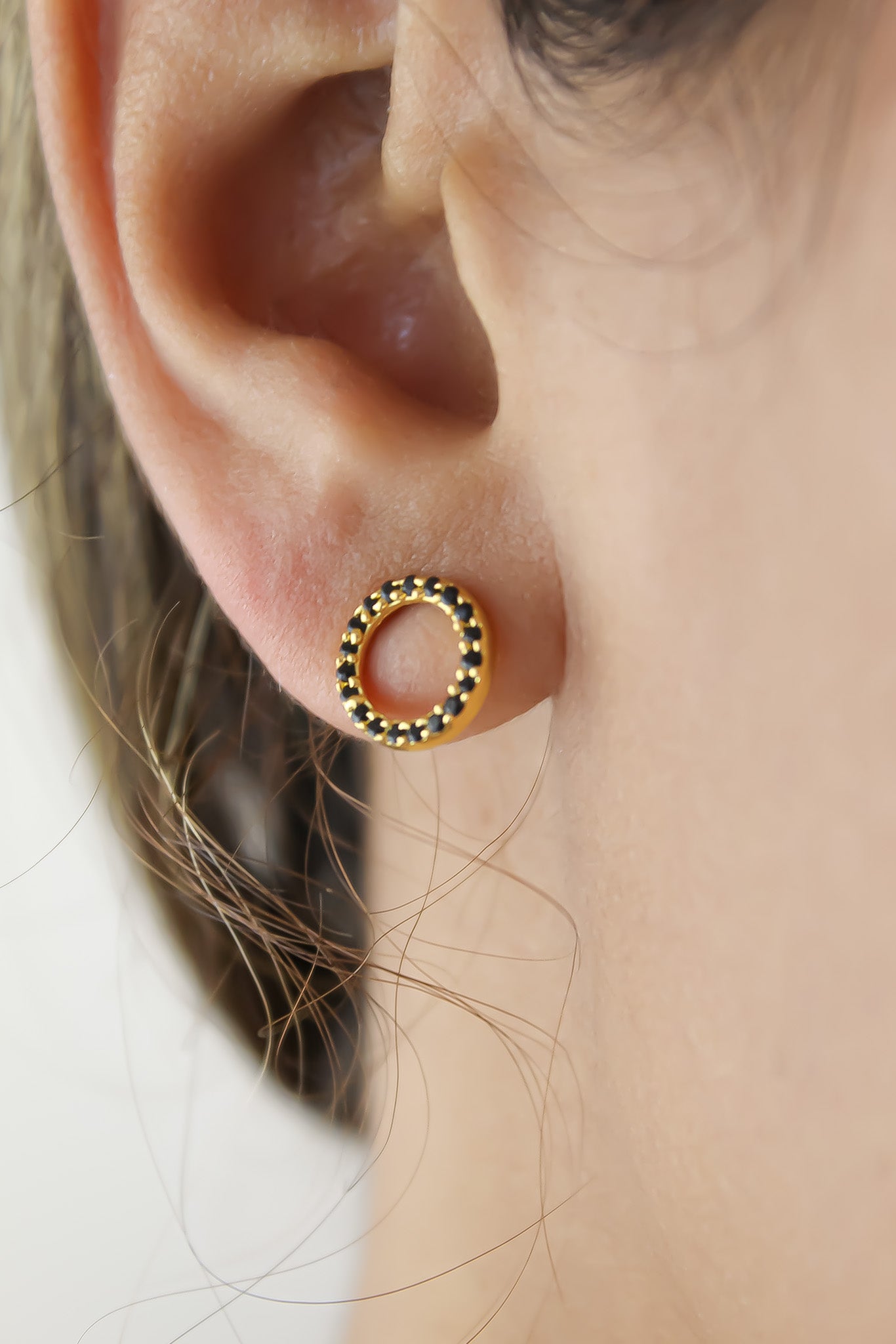 Elegant 18K gold-plated circle earrings adorned with sparkling zirconia stones, designed for pierced ears and hypoallergenic for sensitive skin.