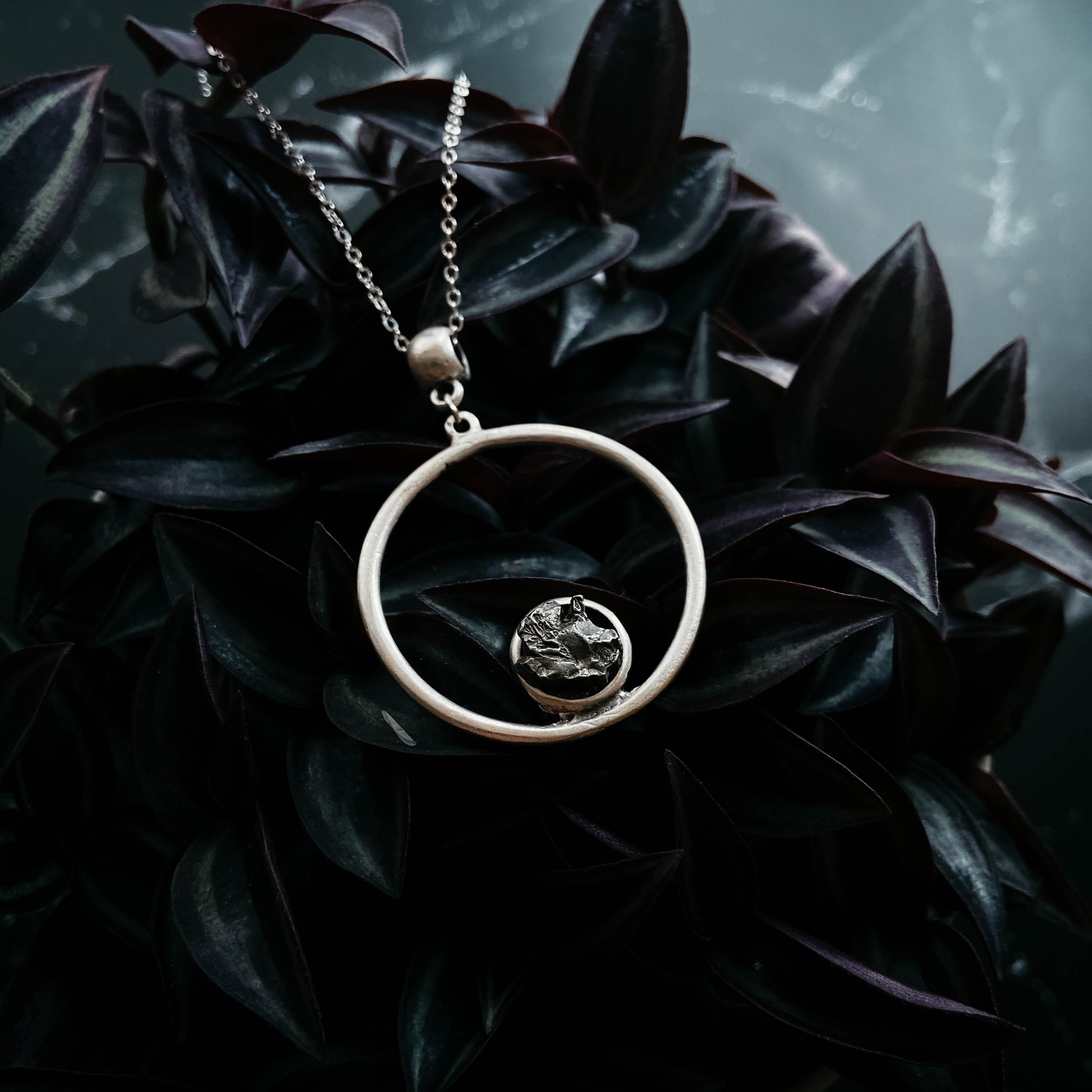 Circle Necklace featuring authentic raw Campo del Cielo meteorite, handcrafted with rhodium plated brass, showcasing a unique cosmic design.