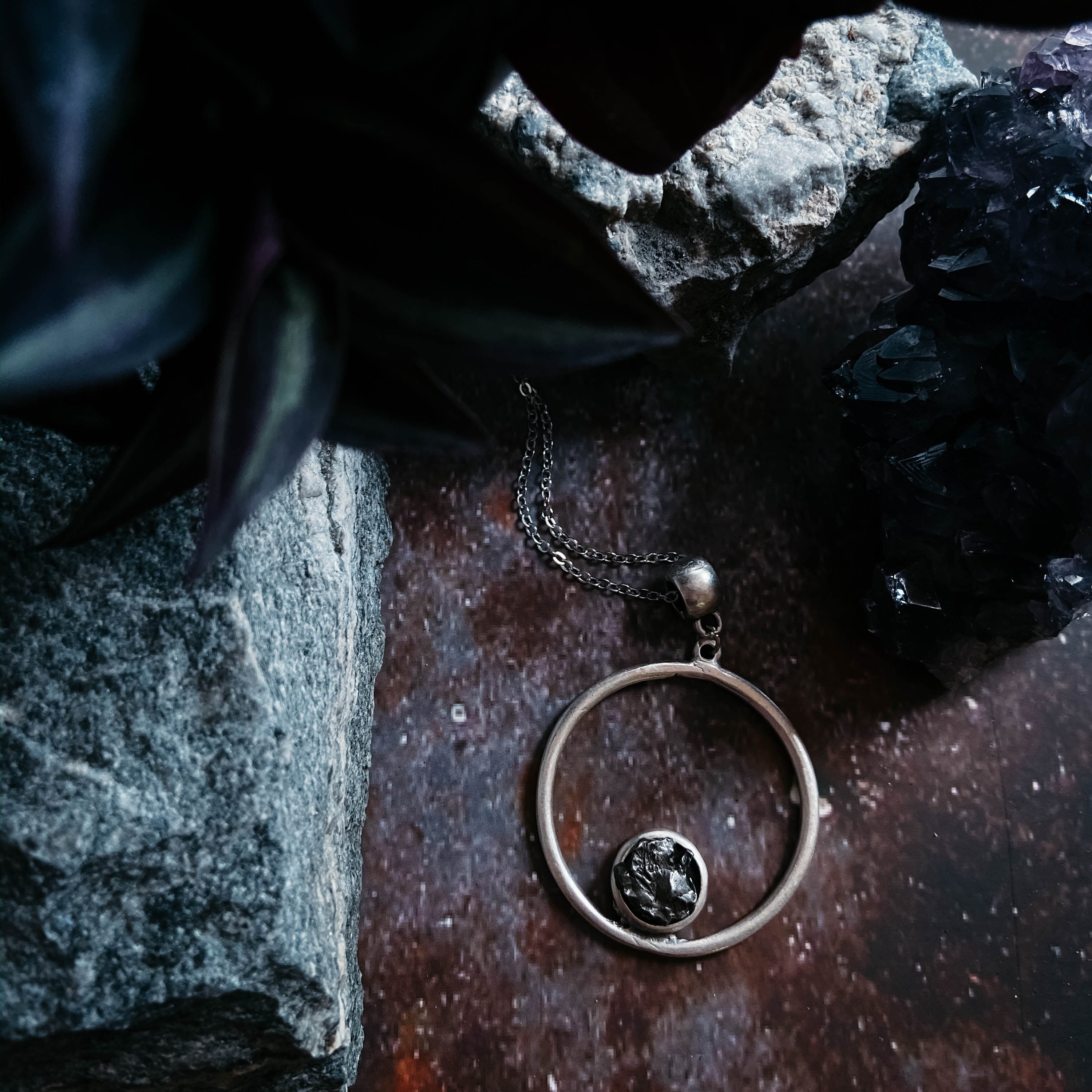 Circle Necklace featuring authentic raw Campo del Cielo meteorite, handcrafted with rhodium plated brass, showcasing a unique cosmic design.