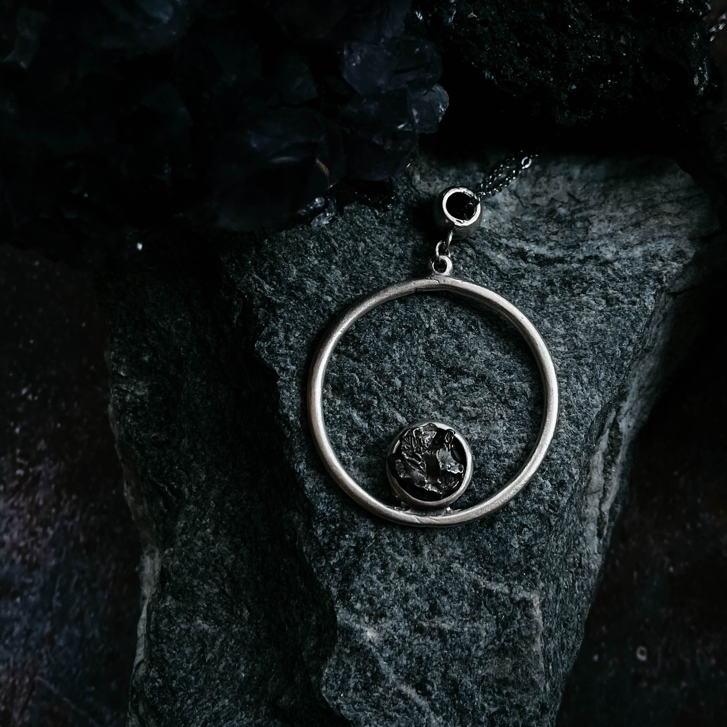 Circle Necklace featuring authentic raw Campo del Cielo meteorite, handcrafted with rhodium plated brass, showcasing a unique cosmic design.