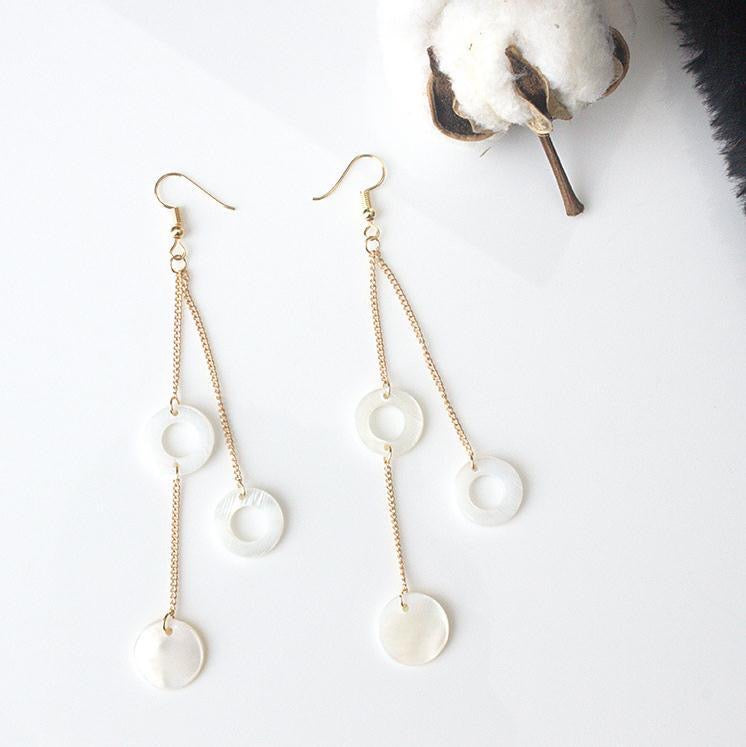 A pair of elegant Circle Shells Long Earrings made from natural shell, showcasing a unique circular design.