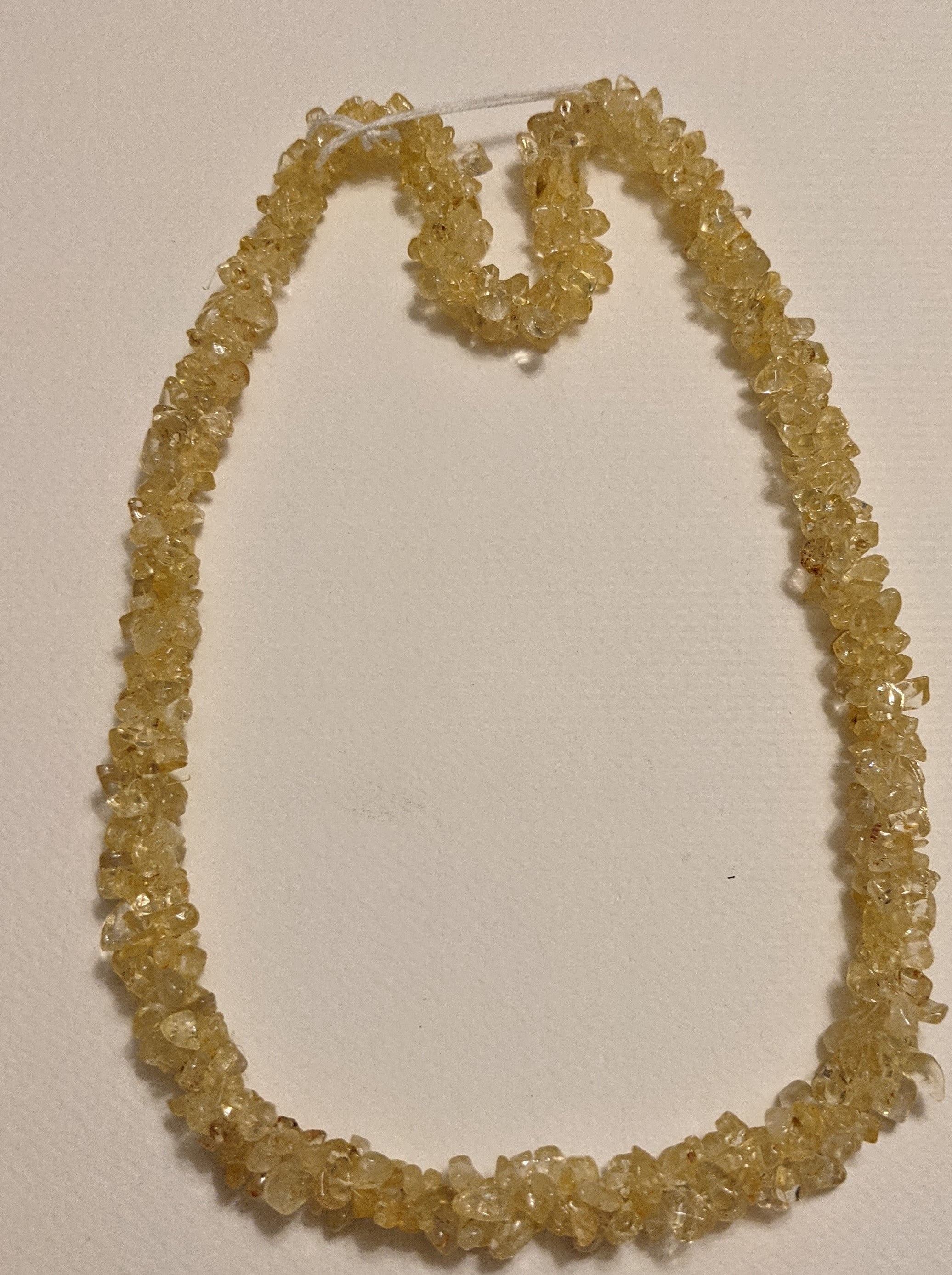 A beautiful handmade Citrine Chips Necklace featuring natural gemstone chips in vibrant yellow hues, measuring 24-25 inches in length.