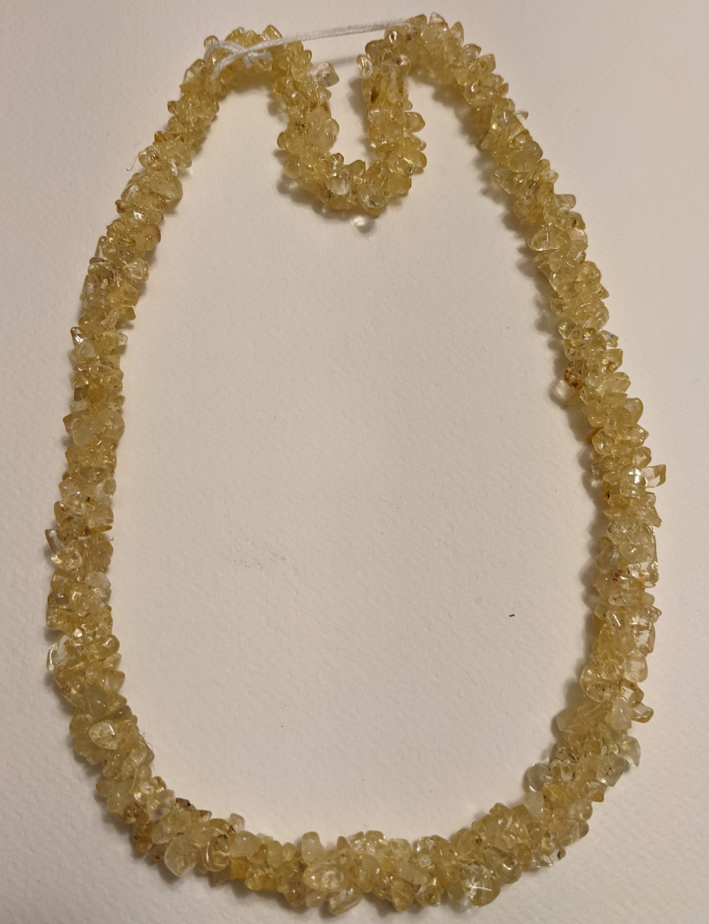 A beautiful handmade Citrine Chips Necklace featuring natural gemstone chips in vibrant yellow hues, measuring 24-25 inches in length.