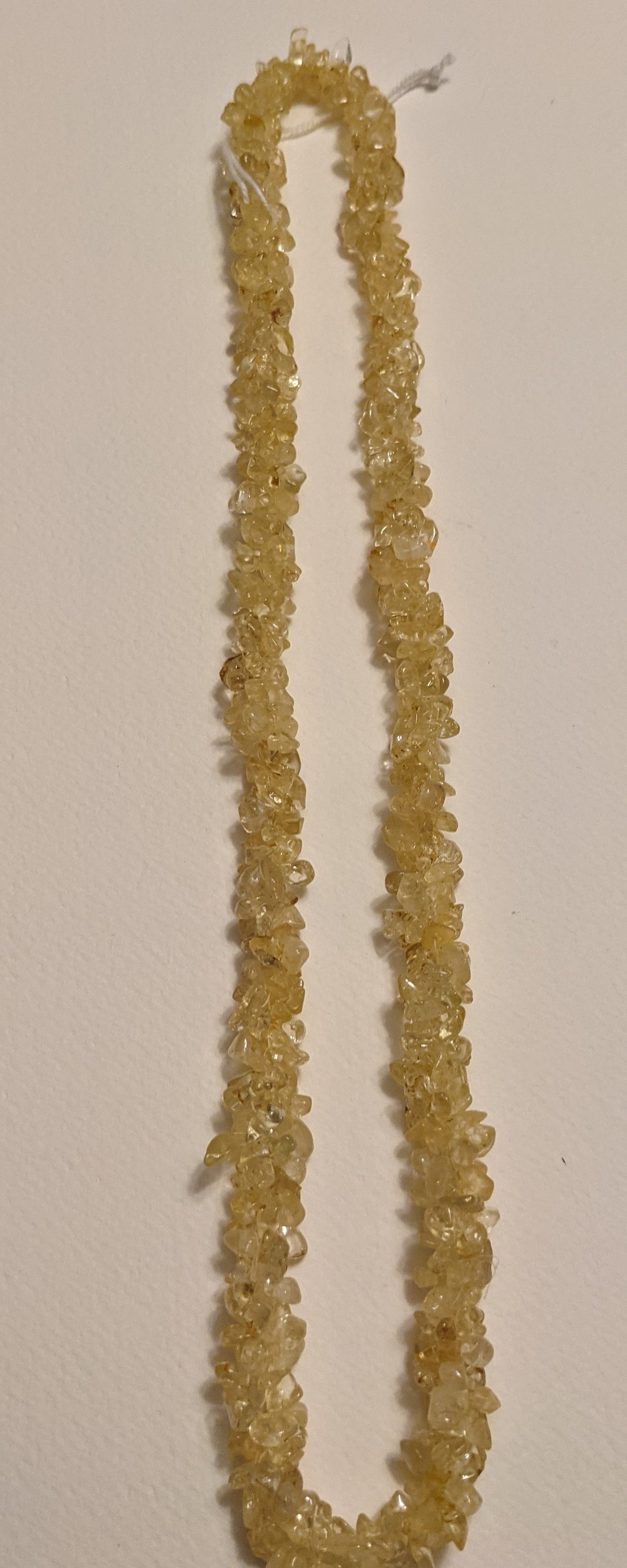 A beautiful handmade Citrine Chips Necklace featuring natural gemstone chips in vibrant yellow hues, measuring 24-25 inches in length.