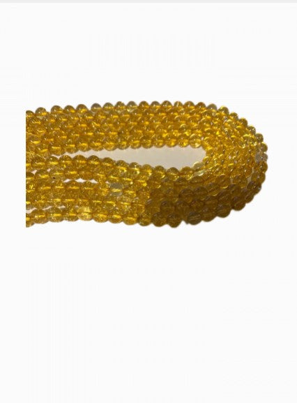 A strand of 8 mm round citrine natural gemstone beads, showcasing their vibrant yellow color and unique natural variations.