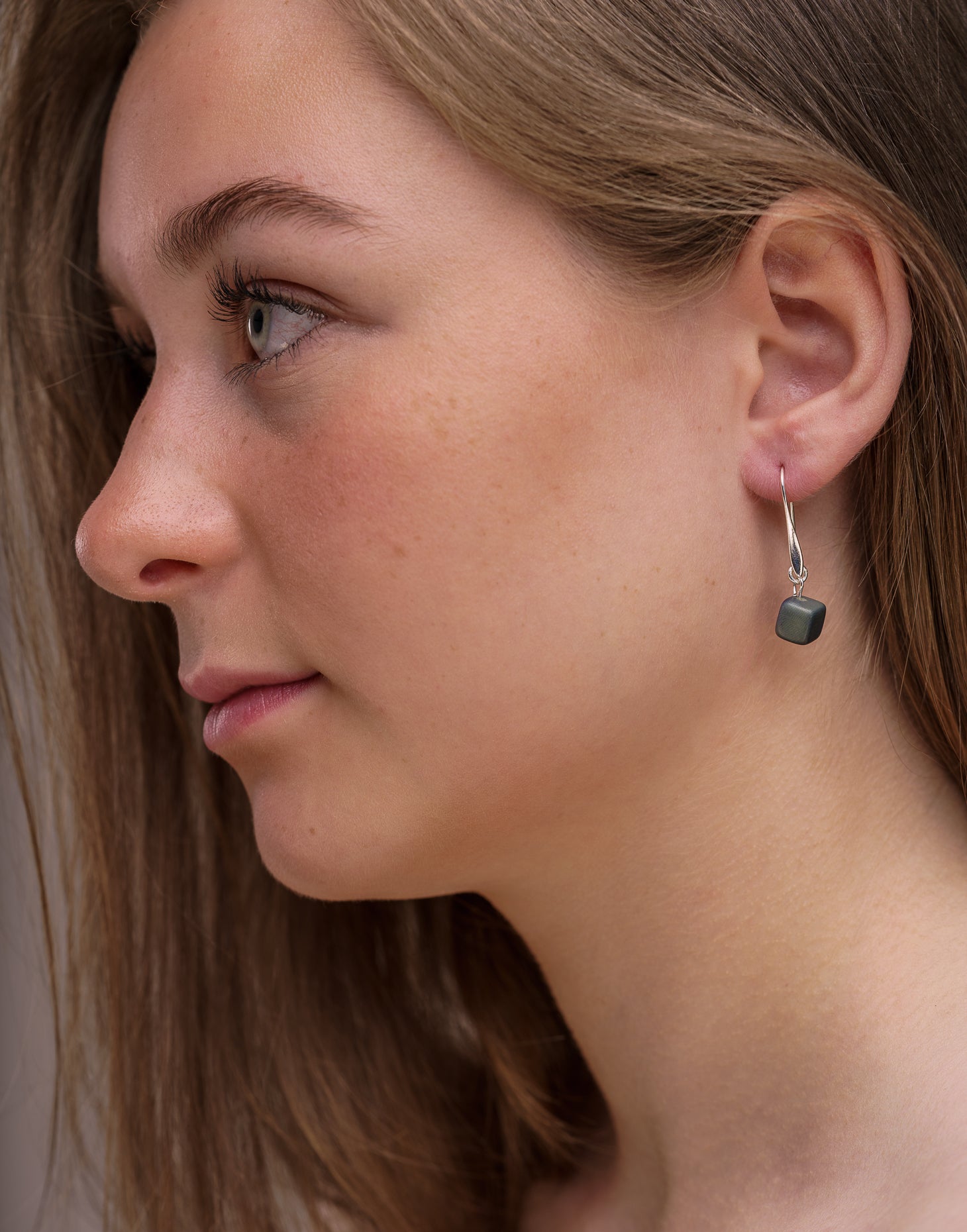 Clara Tagua Earrings featuring handmade tagua nut cubes with silver plated hooks, showcasing eco-friendly craftsmanship.