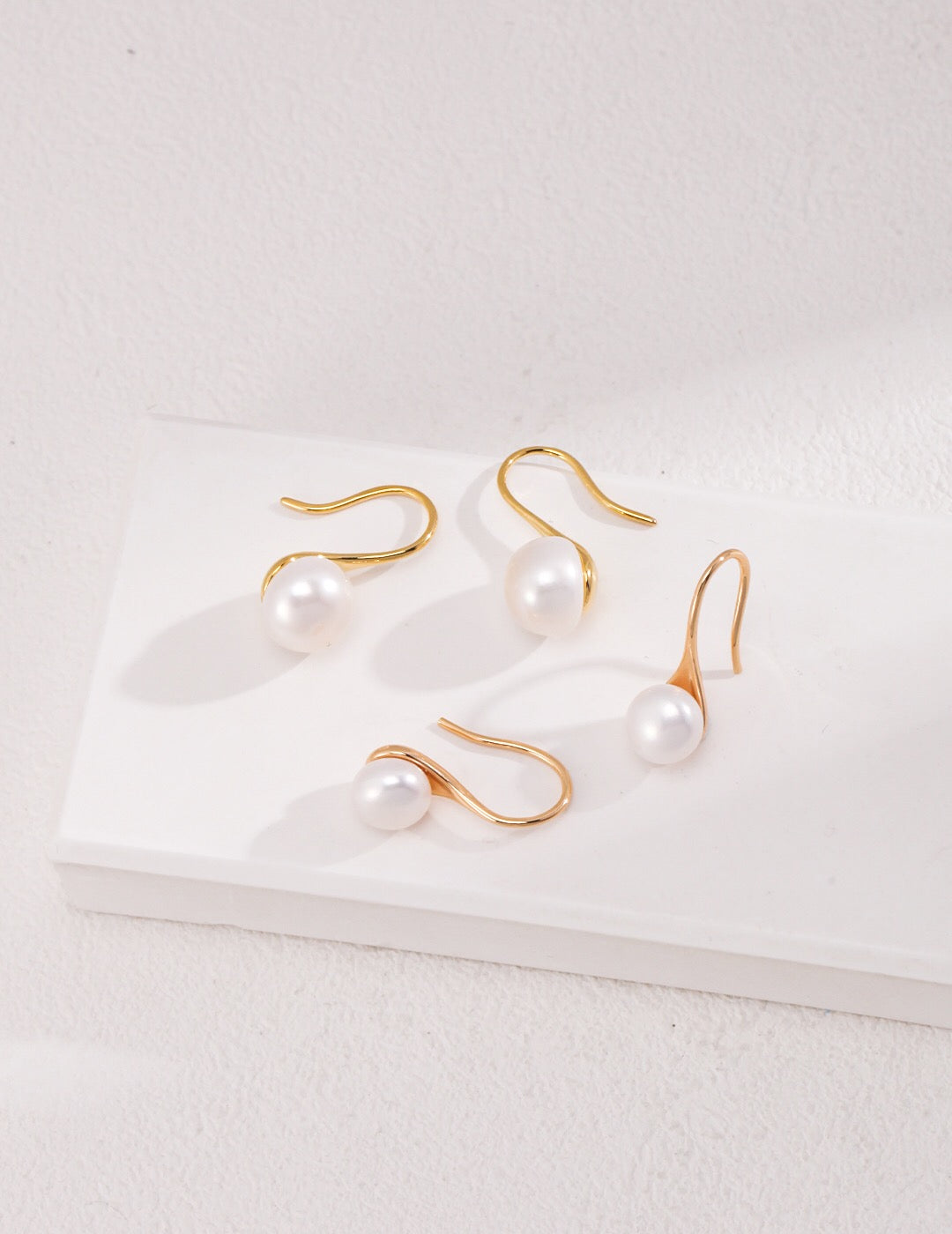 Classic high-heeled pearl dangle earrings featuring natural pearls and sterling silver, elegantly designed for a sophisticated look.