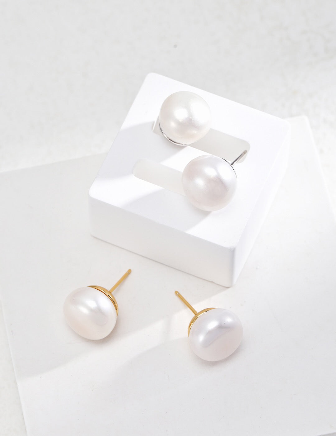 Classic Natural Pearl Stud Earrings featuring 12.5mm natural pearls set in gold vermeil, elegantly displayed in a jewelry pouch.