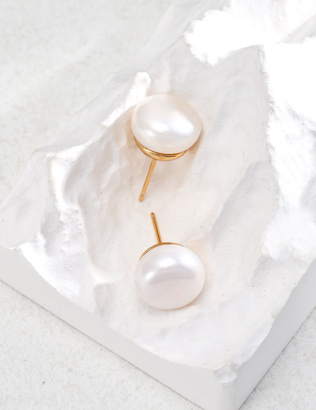 Classic Natural Pearl Stud Earrings featuring 12.5mm natural pearls set in gold vermeil, elegantly displayed in a jewelry pouch.