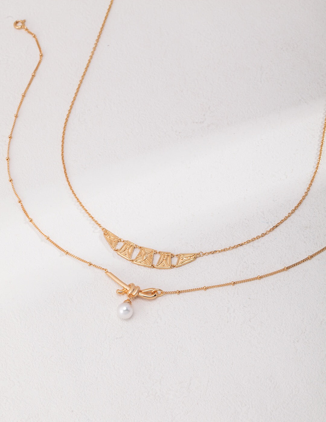 Classic Natural Pearl Twine Necklace featuring natural pearls and gold vermeil accents, elegantly displayed on a soft background.