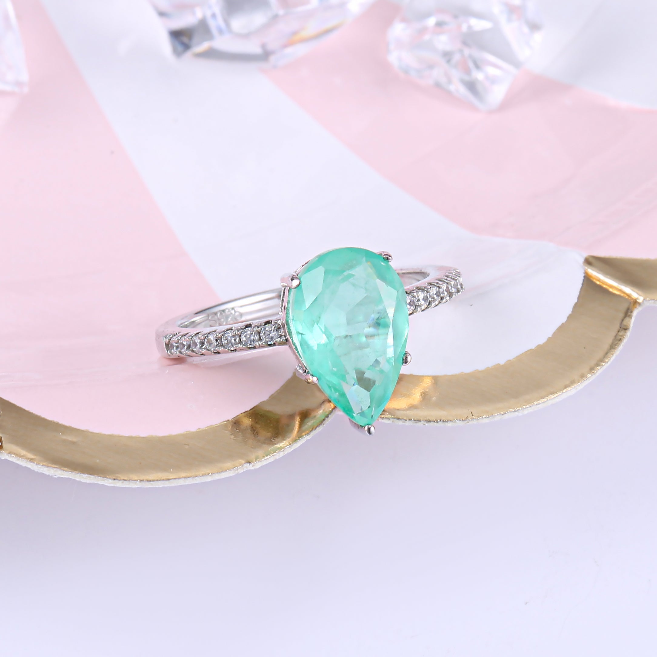 Classic pear shape tourmaline paraiba ring in sterling silver with white gold finish, featuring a vibrant sea blue paraiba stone.